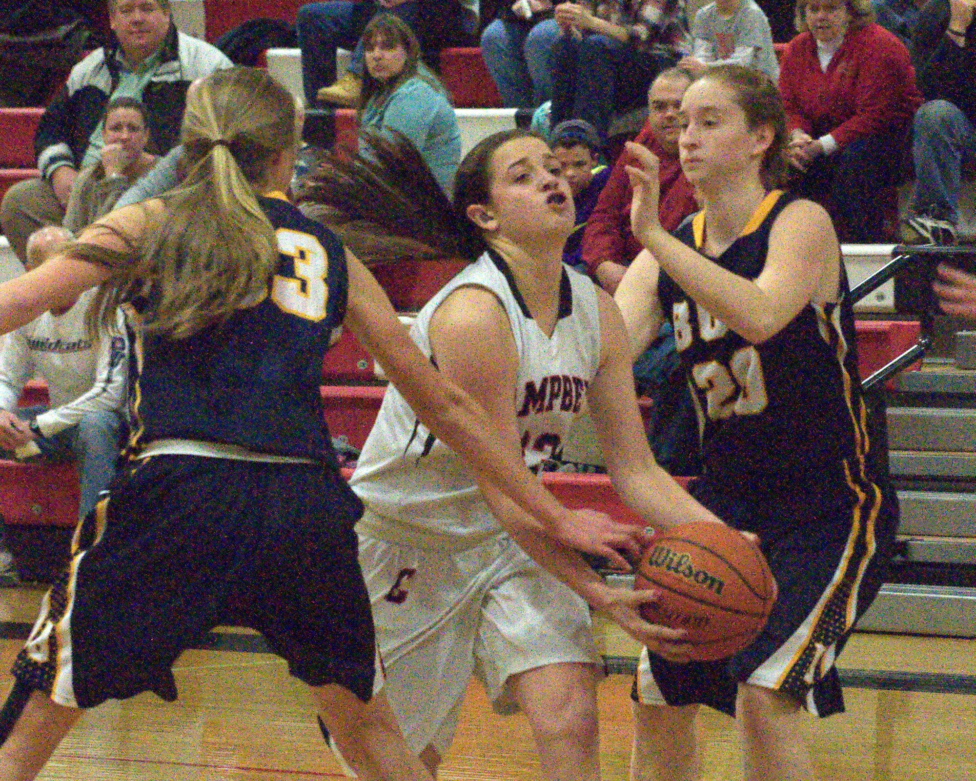 Campbell's Hannah Neild tries to drive past Bow's Abigail Horner, left, and Samantha Lulka during Friday's game.