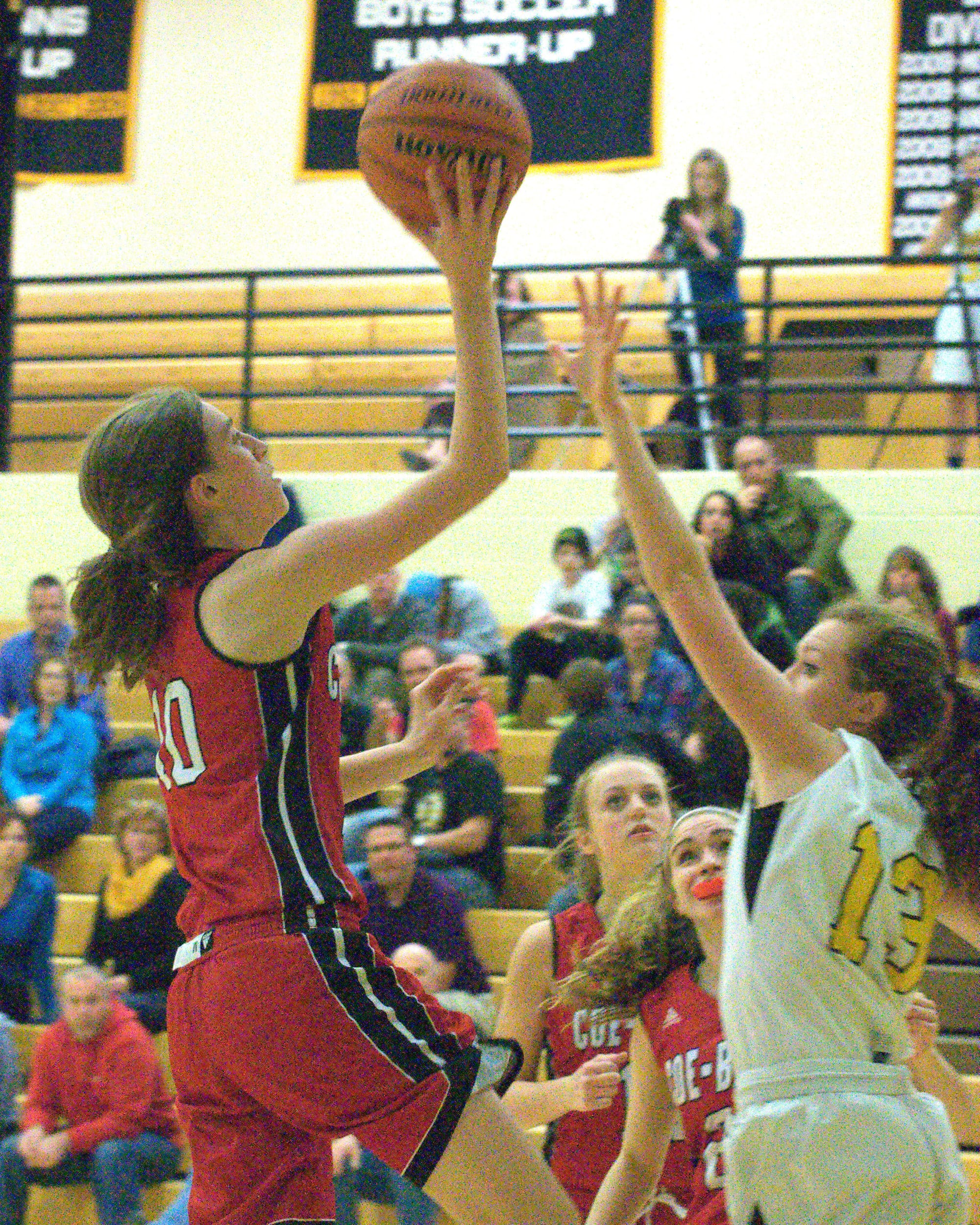 Coe-Brown's Jennifer Schlim puts a shot up over Souhegan's Hannah Kenney.