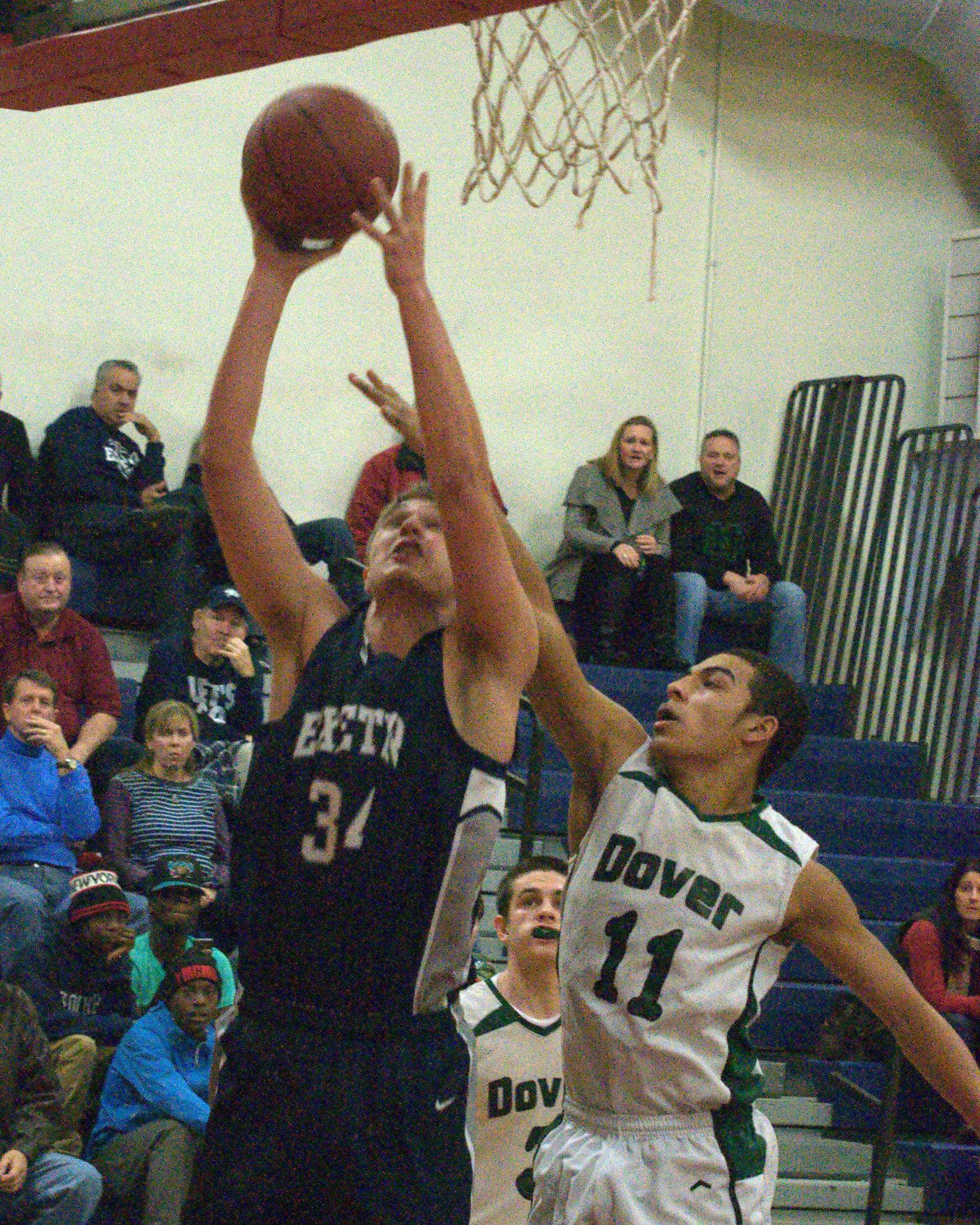 Exeter's Jacob Randolph goes in for a layup as Dover's Dwayne Gordon defends.