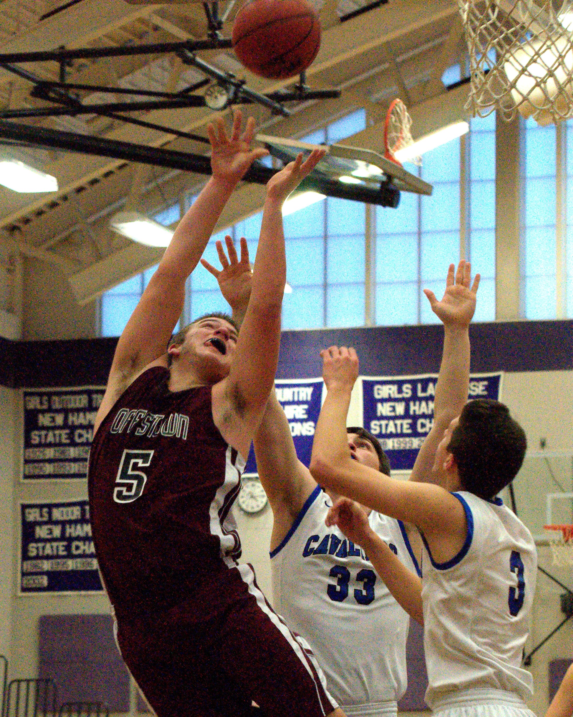 Goffstown's Tim Comeau puts up a shot as Hollis Brookline's Riley Hamel defends during Monday's game at the Chick-Fil-A Holiday Tournament.