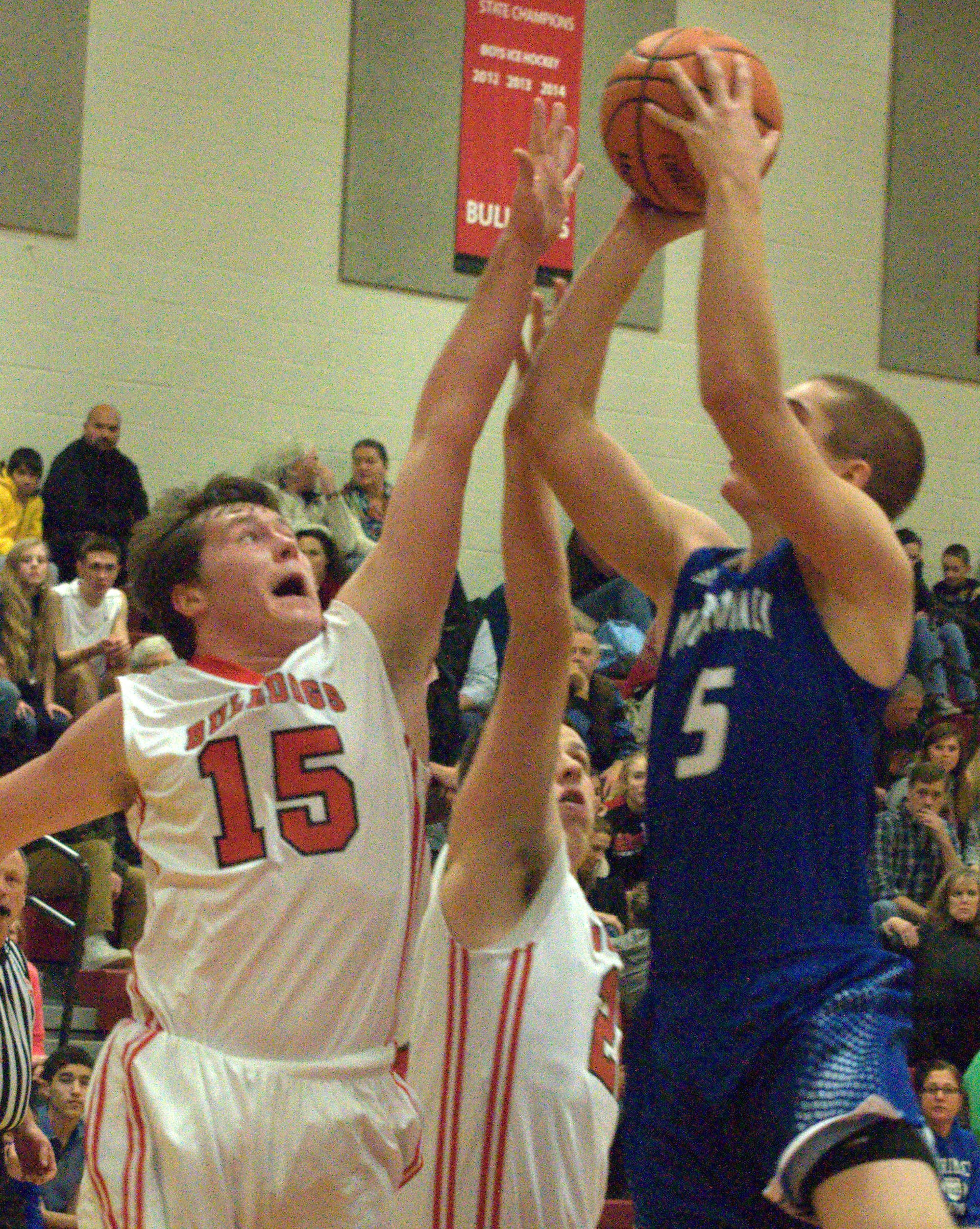 Bedford's Tommy O'Rourke tries to get a piece of a shot by Merrimack's Ian Roberts.