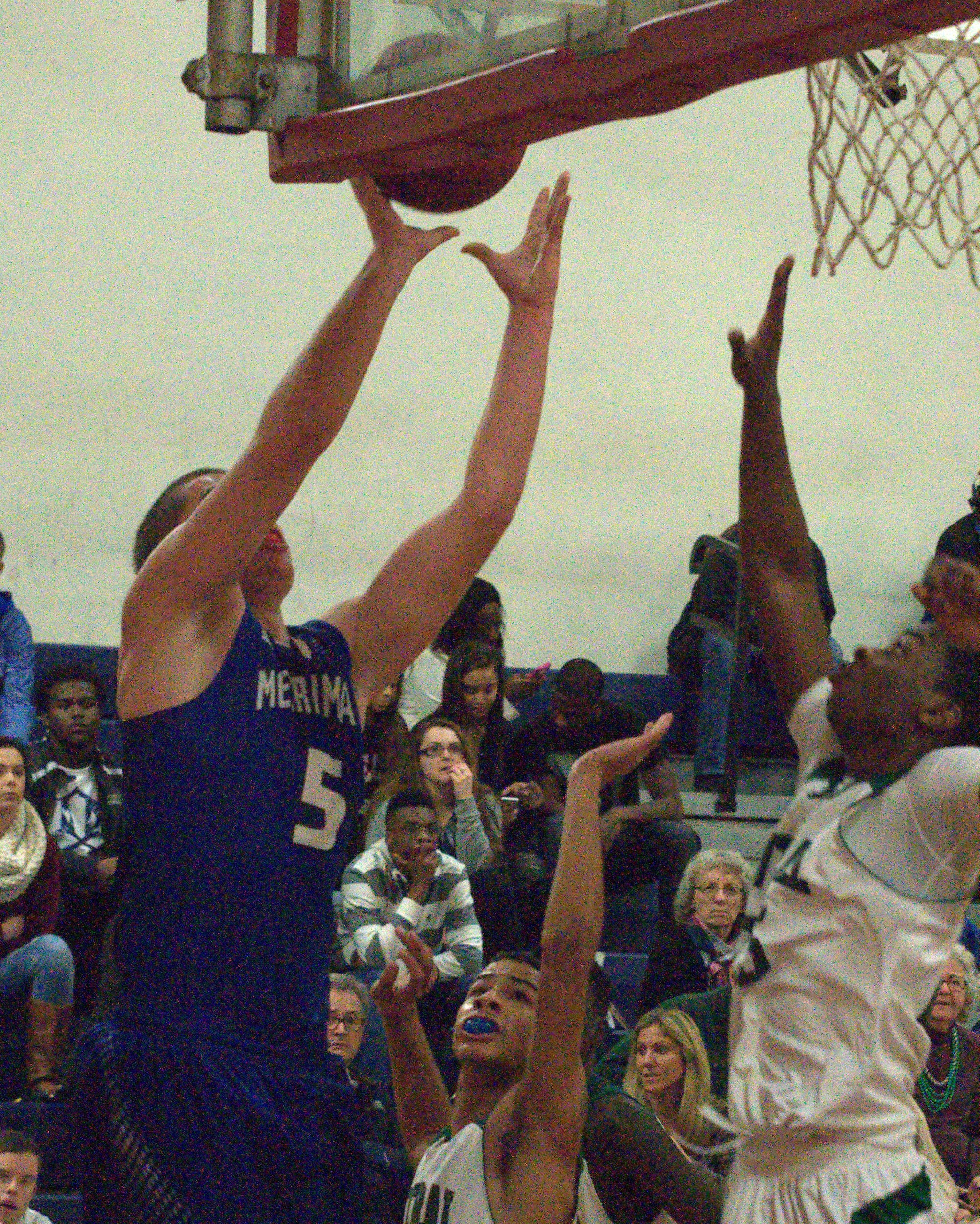 Merrimack's Ian Roberts goes up for a shot as Manchester Central's Jonathin Makori defends Sunday during the Queen City Invitational Tournament.
