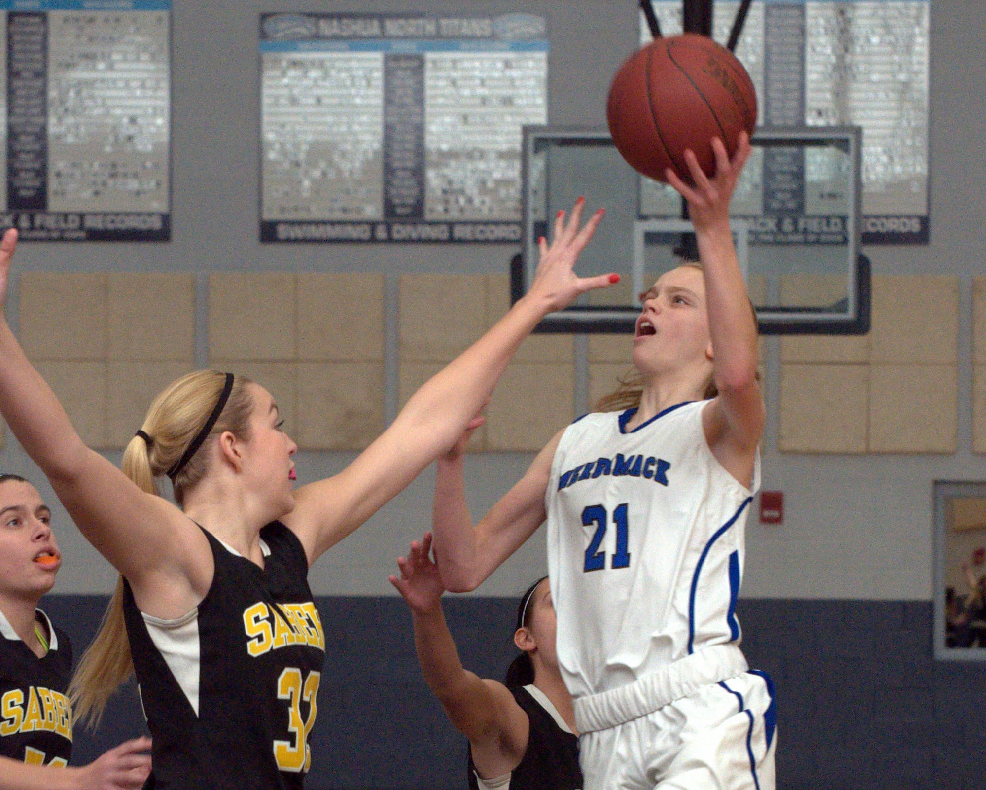 Merrimack's Sabrina Johnson drives to the basket against Souhegan's Alli Canavan defends during Friday's game.
