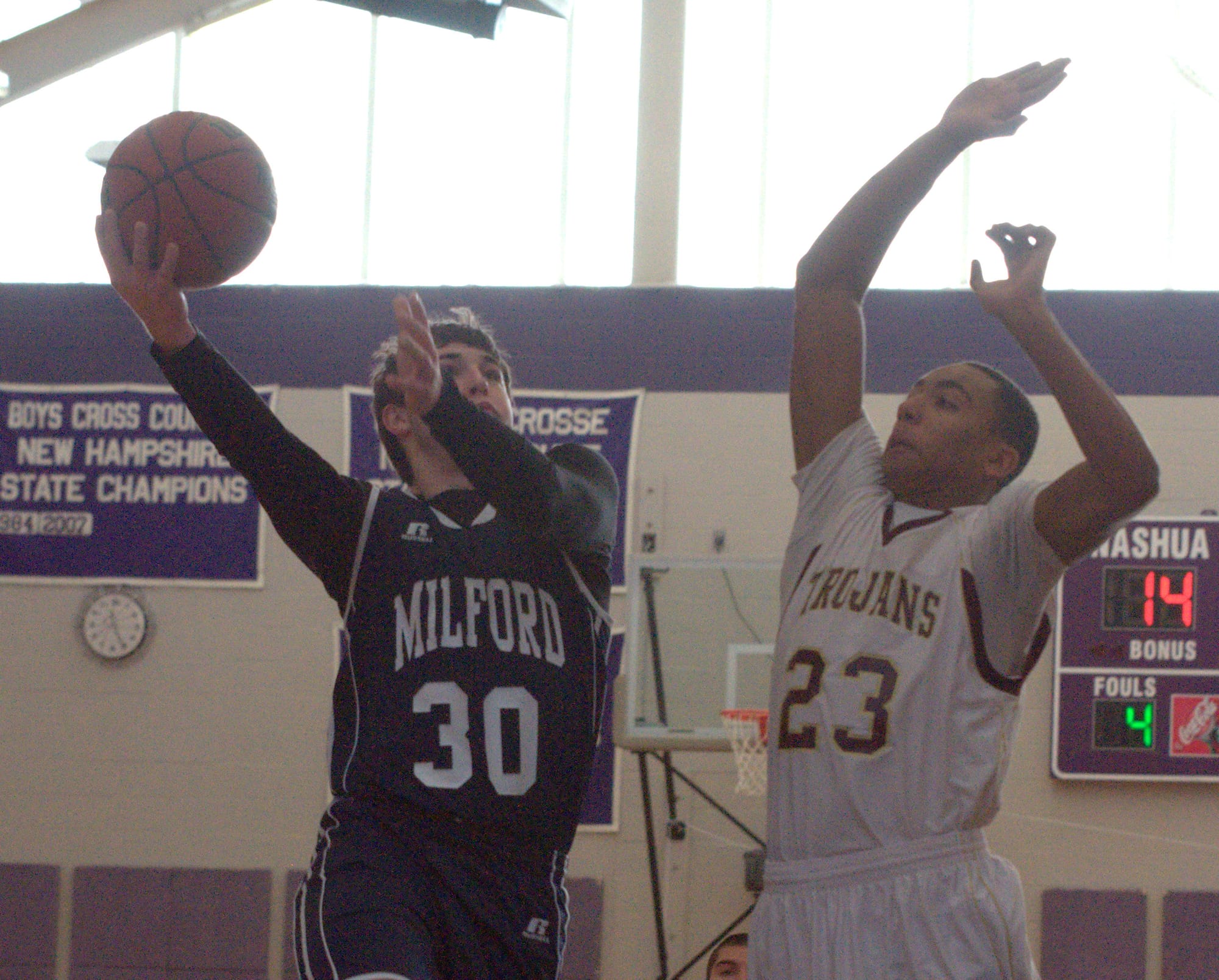 Milford's Drew Lesmerises drives to the basket as Thornton's Corey Hart defends during Wednesday's game.