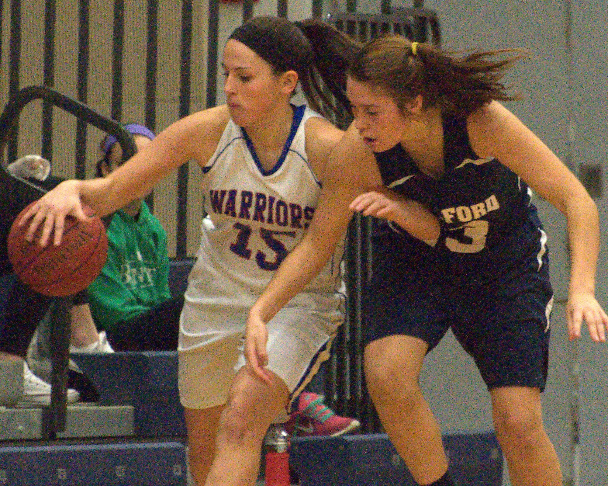 Milford's Becca Cleary tries to knock the ball away from Winnacunnet's Kathleen Valcich.