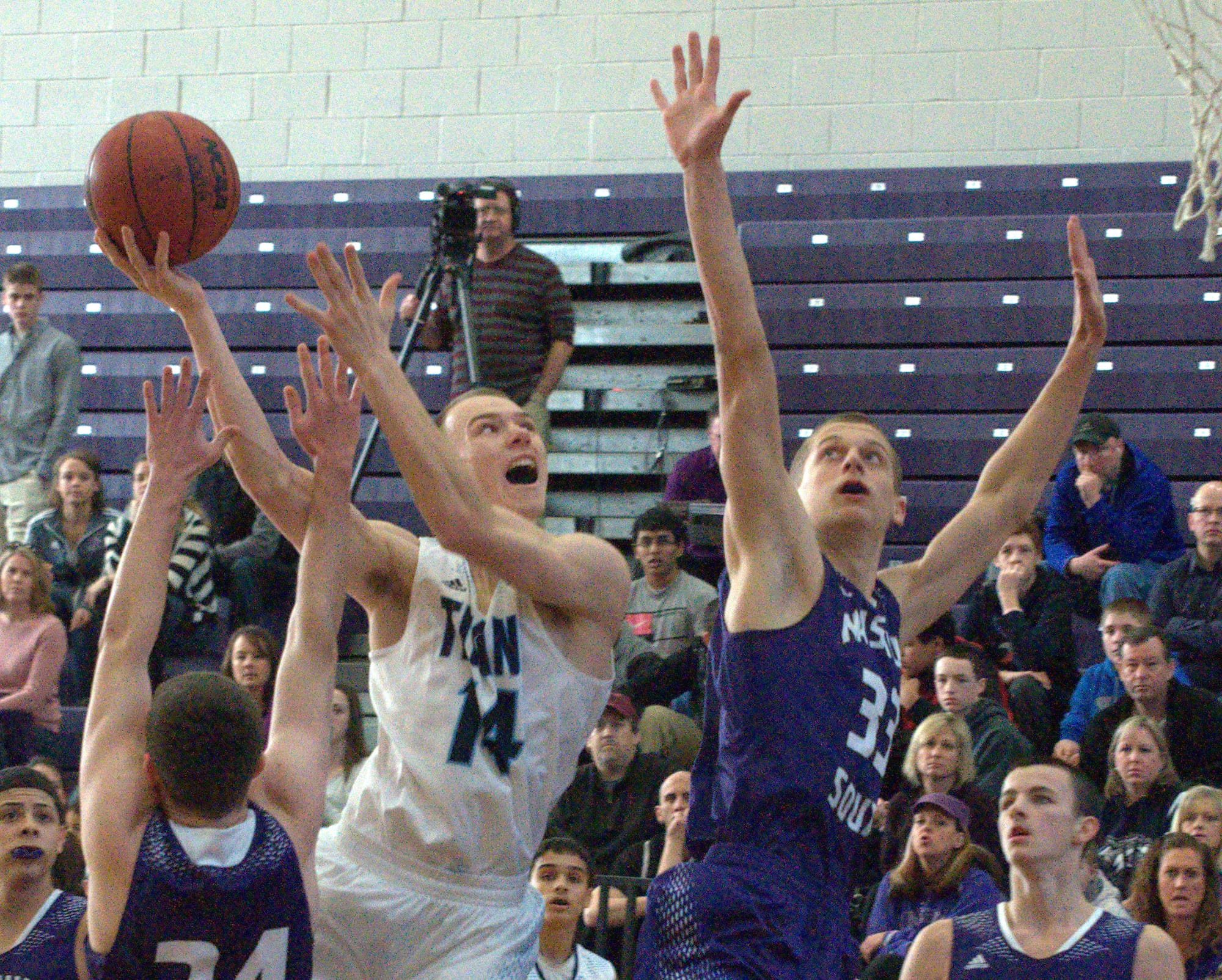 Nashua North's Brennan Kastens takes a shot Wednesday as Nashua South's Mike Osgood defends.
