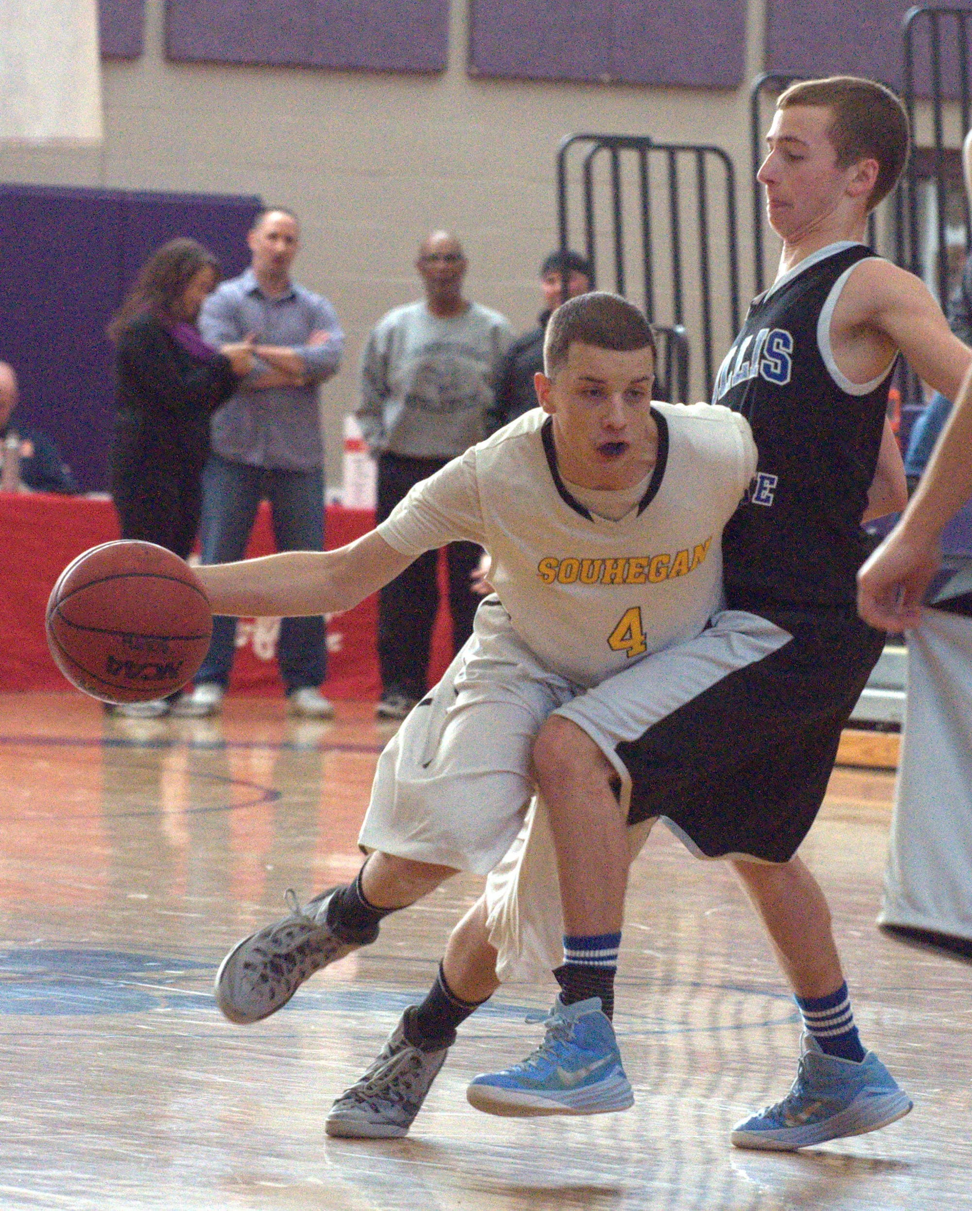 Souhegan's Alex Hill tries to get by Hollis Brookline's Nick Fothergill during Wednesday's game.