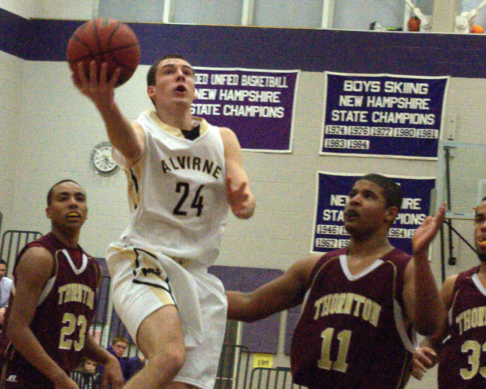 Alvirne's Alex Wetmore drives by Thornton's Rome Pura during Monday's game at the Chick-Fil-A Holiday Tournament.