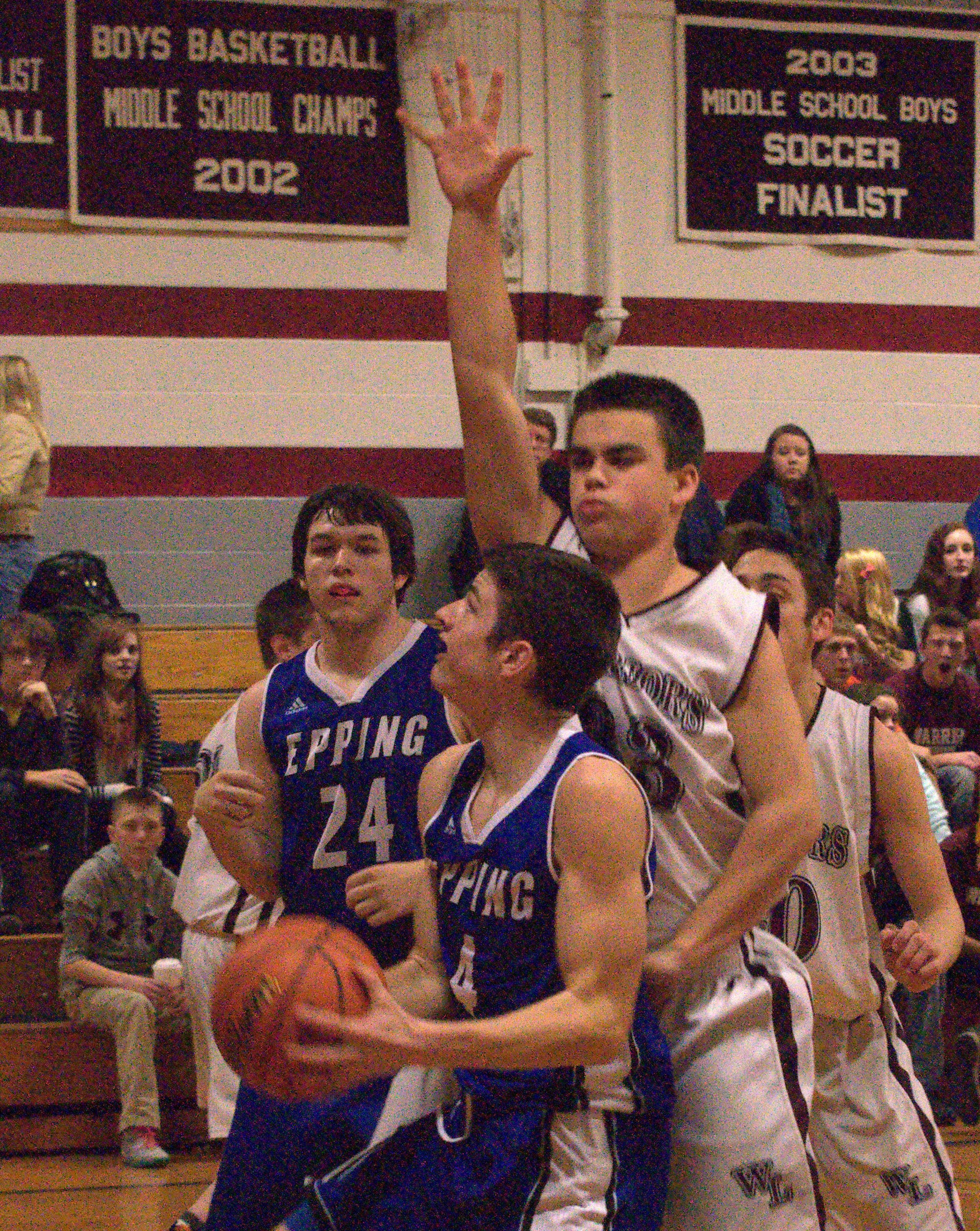 Wilton-Lyndeborough's Casey Lane defends as Epping's Dylan Derosier tries to get to the basket.