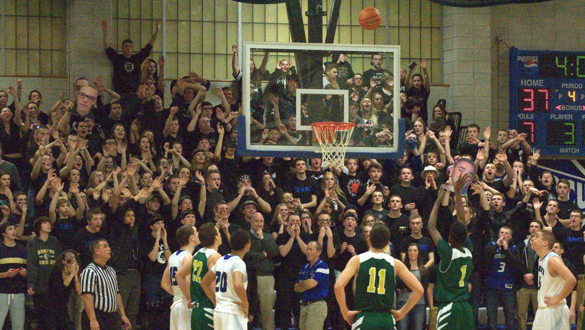 The Merrimack student section tries to distract Bishop Guertin during a free throw Friday night.