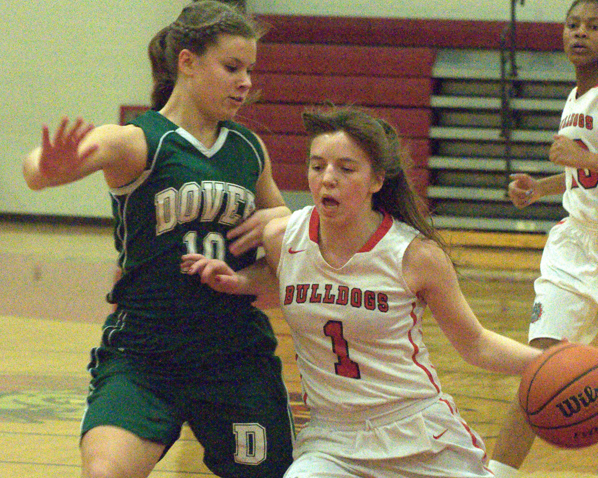 Dover's Kaitlin McDermott tries to keep Bedford's Bri Purcell from driving to the basket.