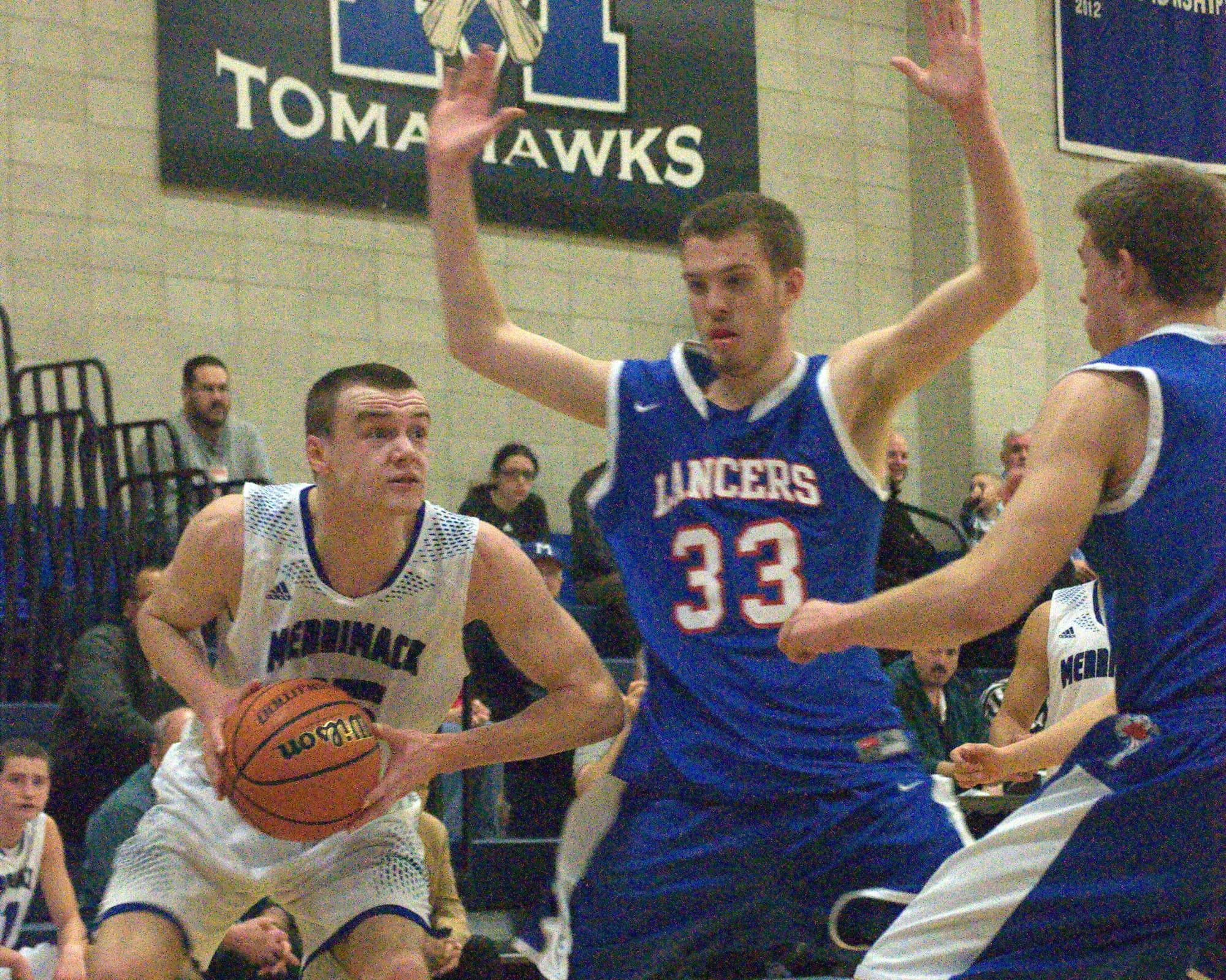 Merrimack's Dylan Richardson looks to get to the basket as Londonderry's Marc Corey defends during Friday's game.