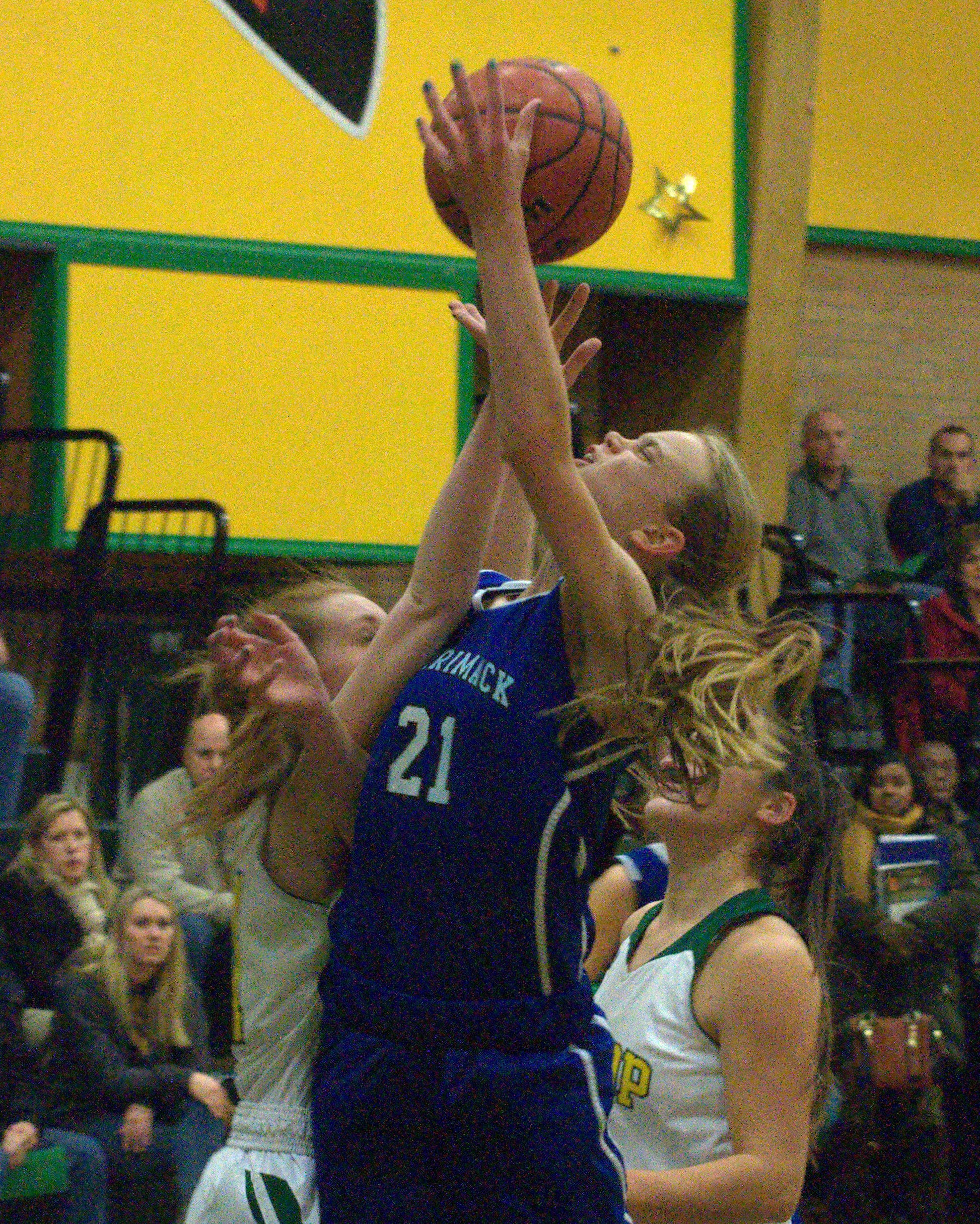 Merrimack's Sabrina Johnson is fouled on her way to the basket.