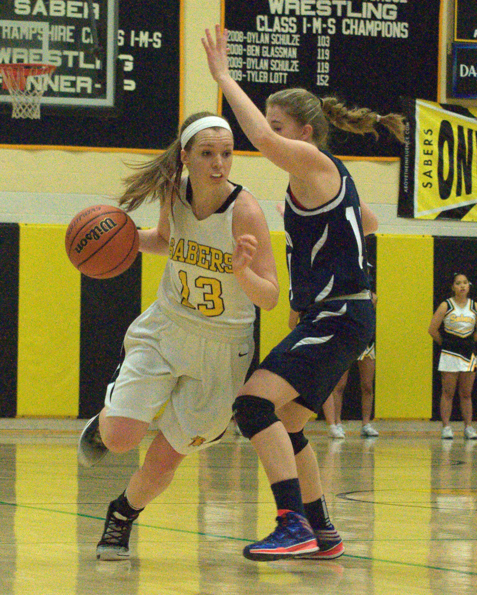Milford's Jess Ryan tries to slow down Souhegan's Hanna Kenney.