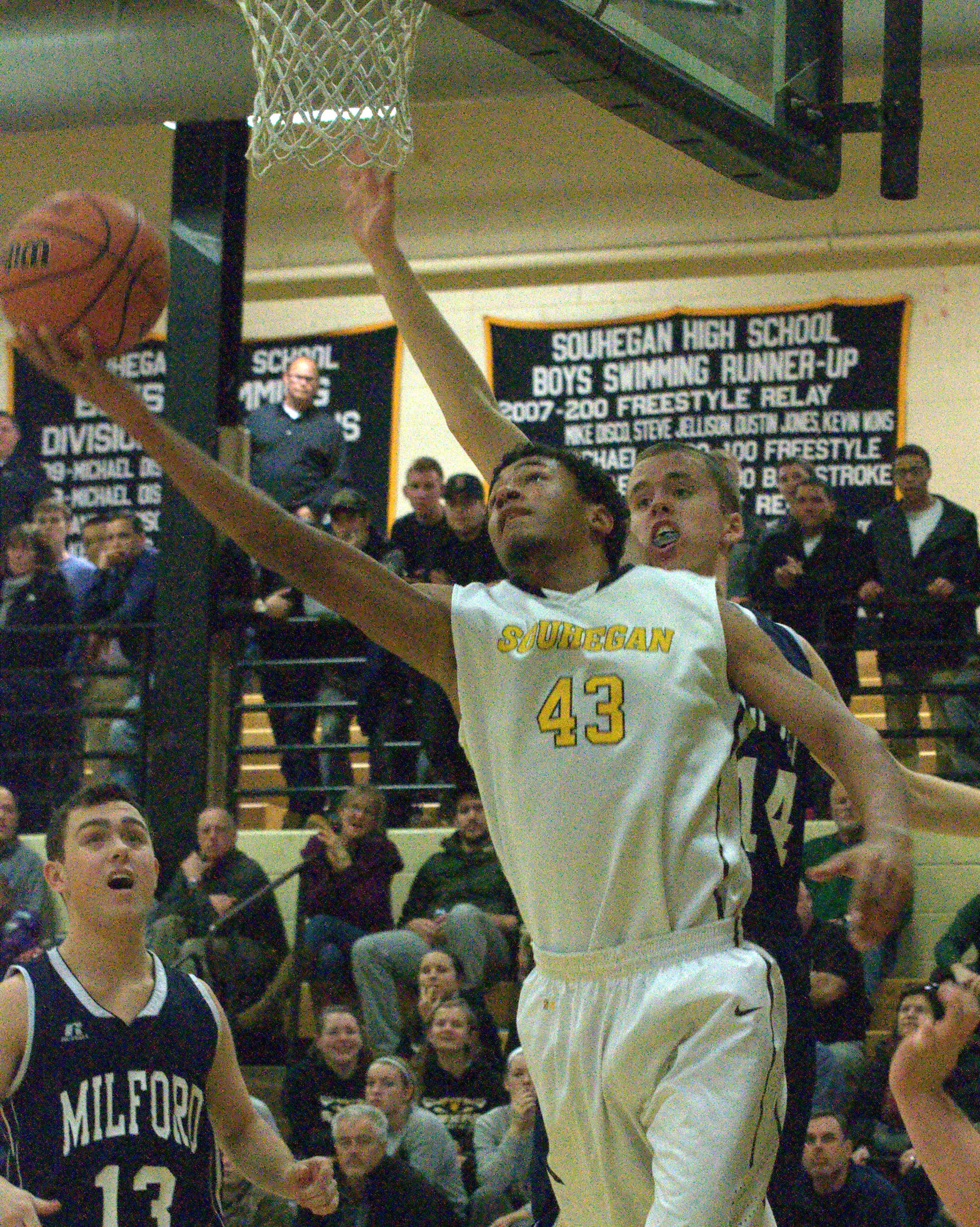 Souhegan's Jerrell Webster tries to get by the Milford defense.