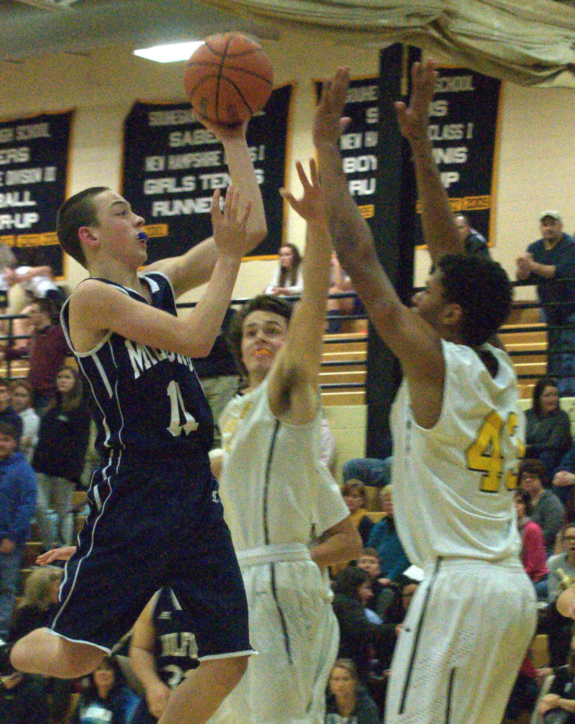 Milford's Ryan Banuskevich drives to the basket as Souhegan's Jerrell Webster defends during Tuesday's game.