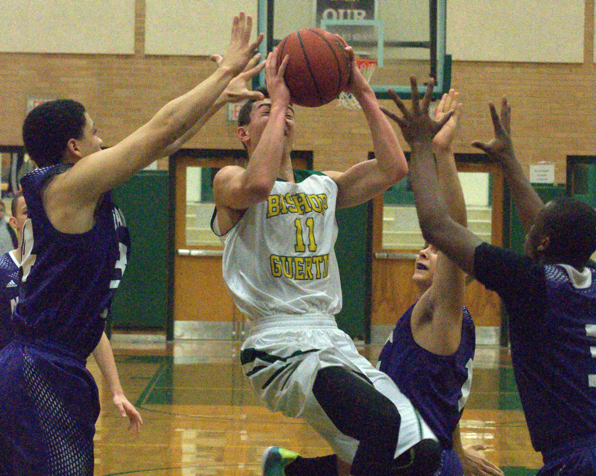 Bishop Guertin's Jack Zimmerman tries to put up a shot over three South defenders.