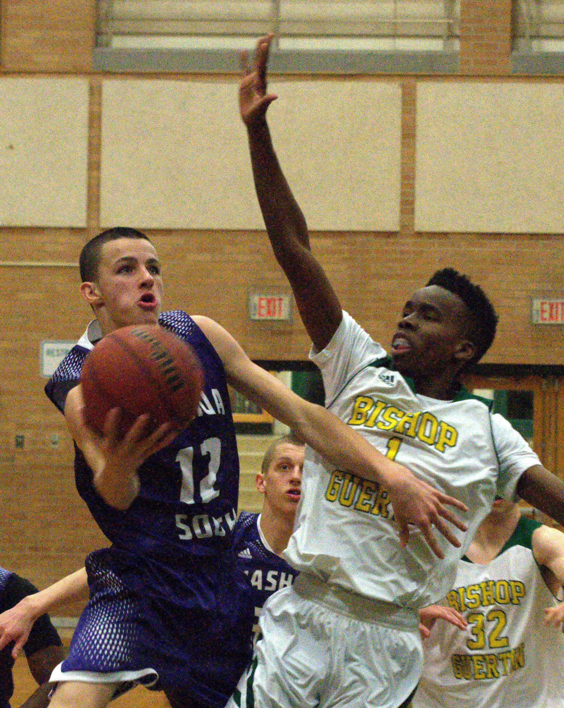 Nashua South's DJ Frechette drives to the basket as Bishop Guertin's Alex Arika defends.