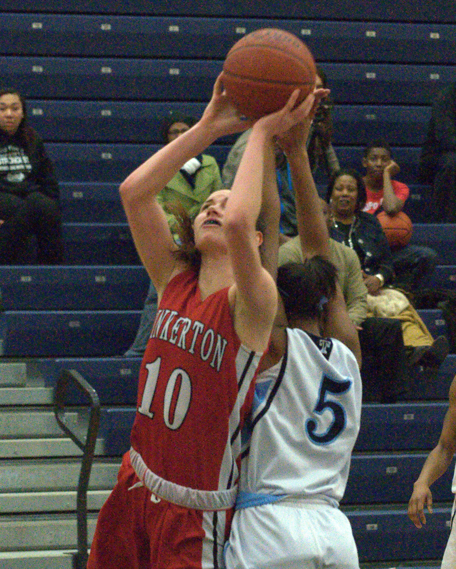 Pinkerton's Valerie Martin tries to put a shot up over Nashua North's Micheala Choate.