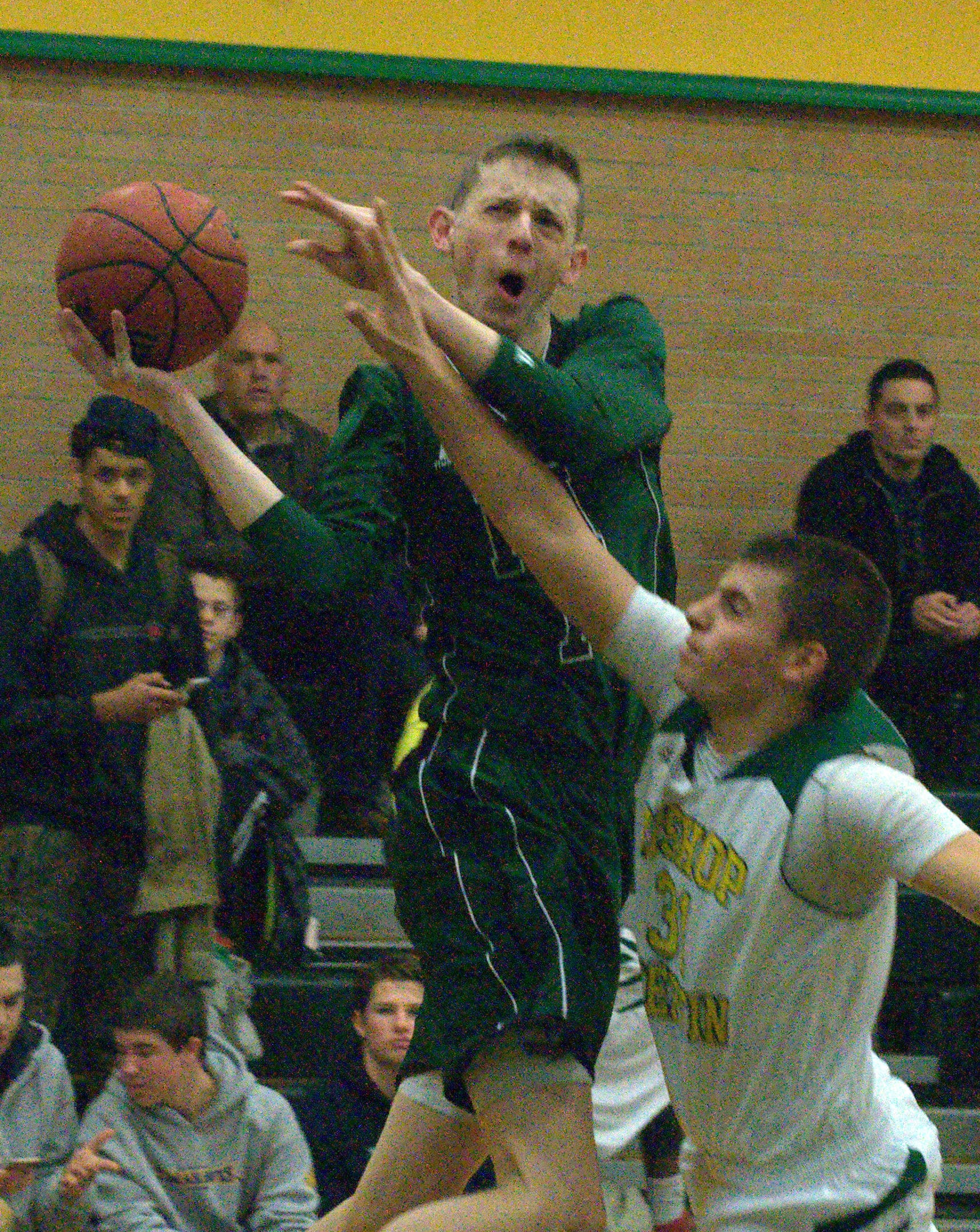 Bishop Guertin's Kyle Gavin fouls Pembroke's Max Curran during Monday's game.