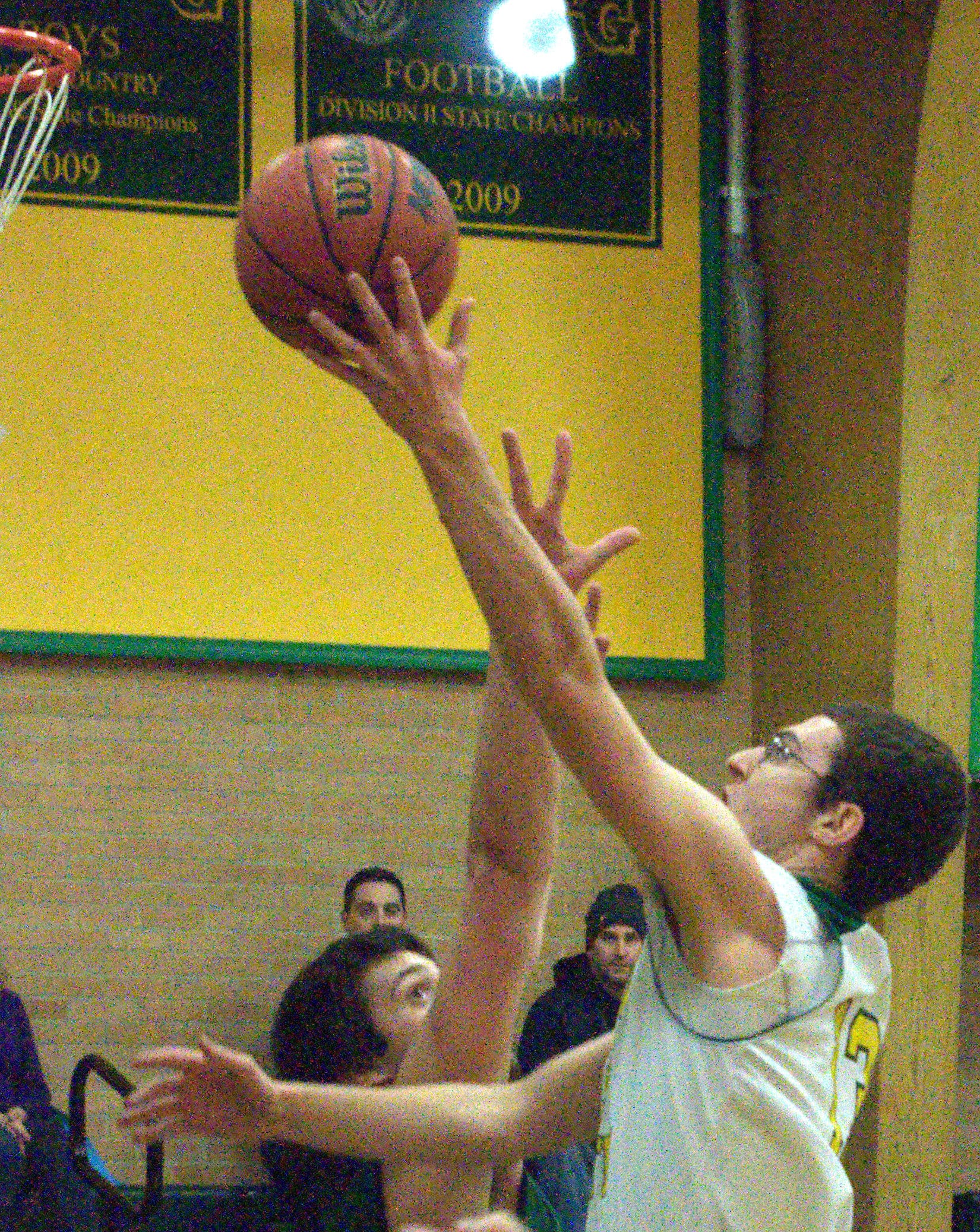 Bishop Guertin's Chad Olivieri goes in for a layup as Pembroke's Dominic Timbas defends.