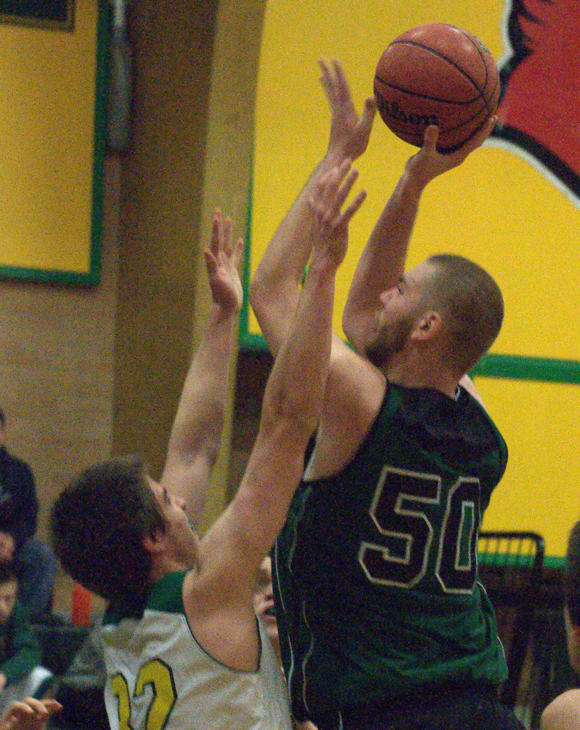 Pembroke's Rob Wilson puts up a shot over Bishop Guertin's Garrett Camacho.