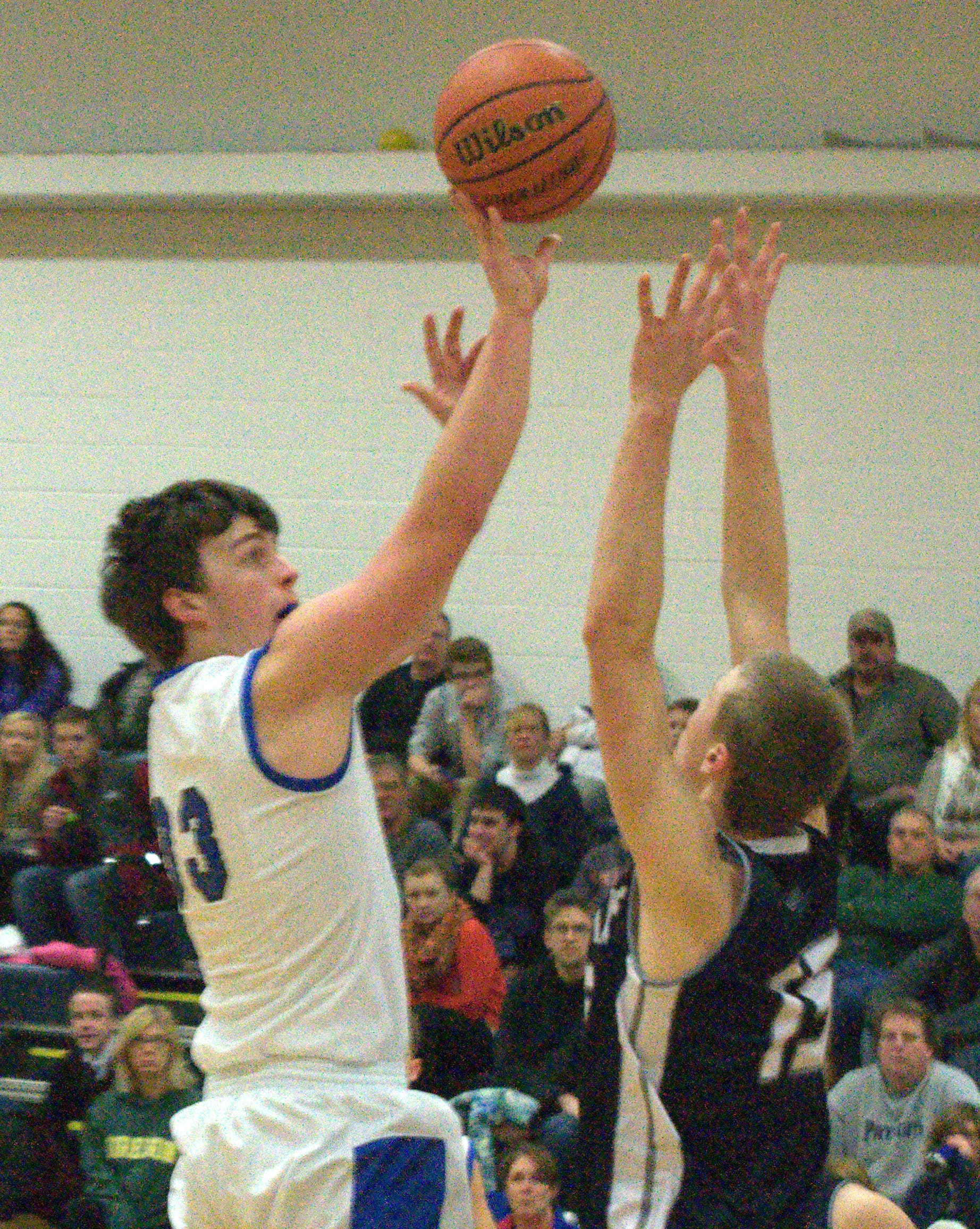 St. Thomas' Sean Kelly tries to get a hand on a shot by Hollis Brookline's Trevor Bowler.