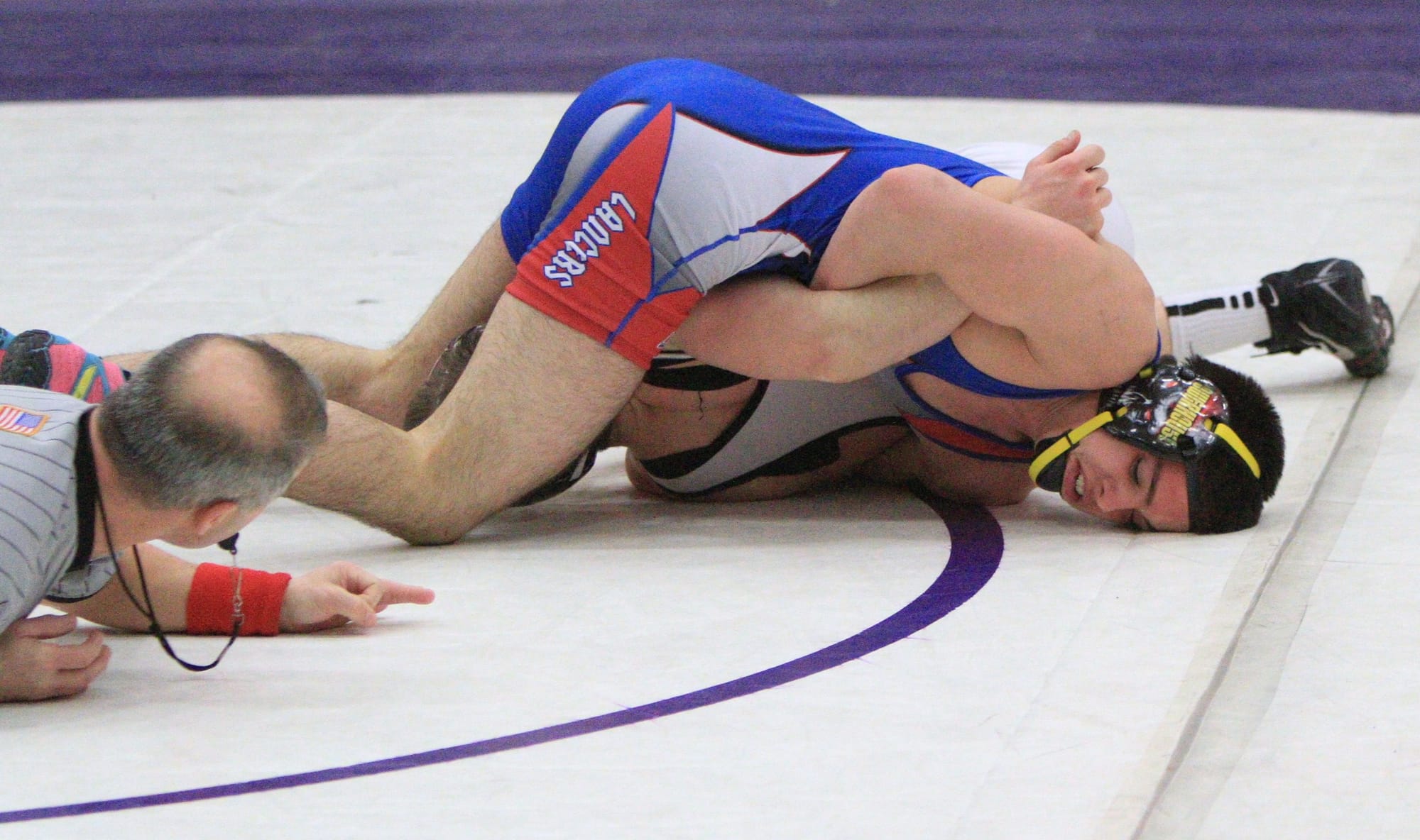 Londonderry's Jean-Luc Lemieux tries to pin Timberlane's Danny Scalzo in the 138-pound title match during Saturday's NHIAA Division I Championships at Nashua South. Lemieux went on to win the title with a 7-0 decision. (Courtesy photo by George Scione)
