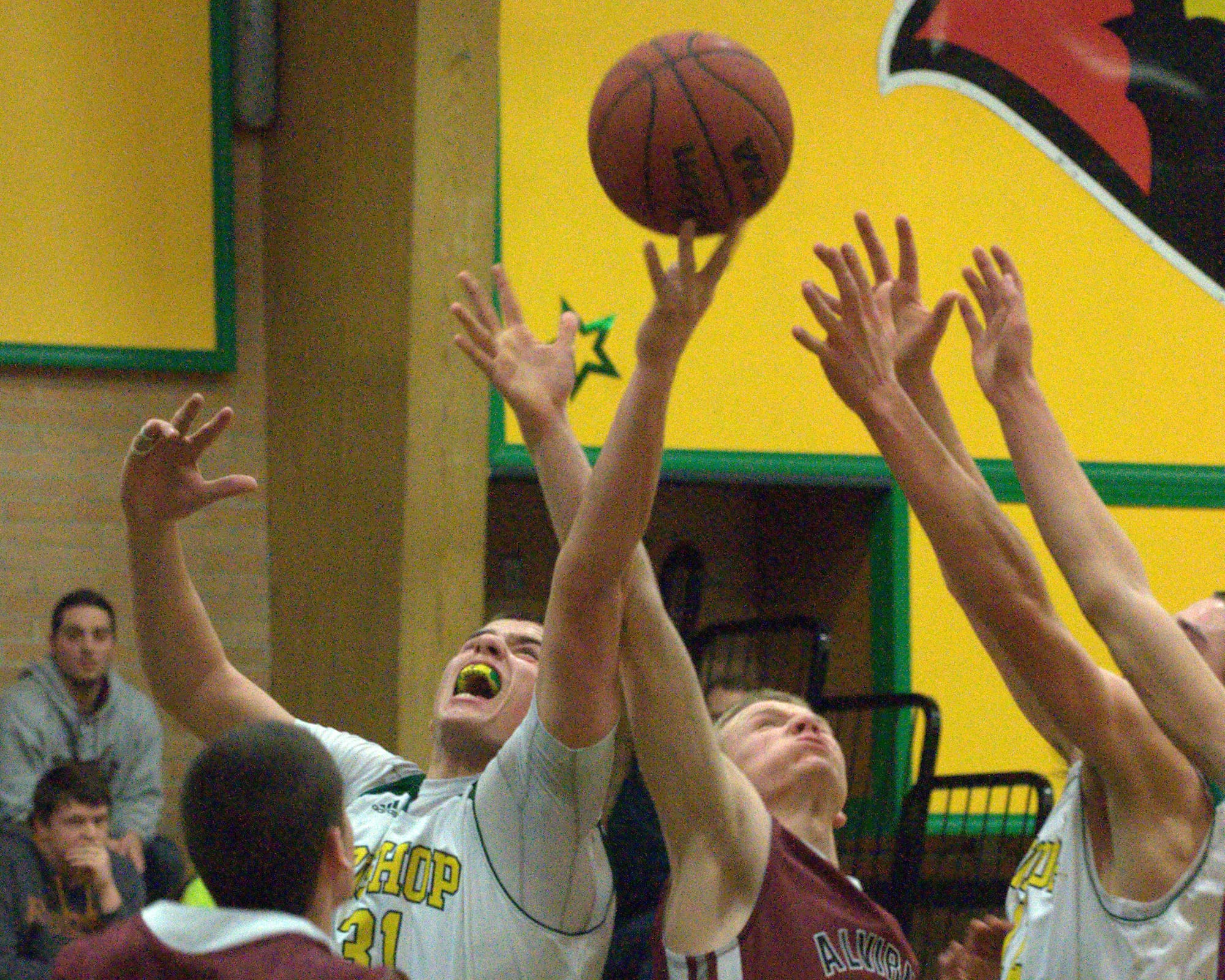 Bishop Guetin's Kyle Gavin and Alvirne's Danny Brown battle for a rebound during Tuesday's game.