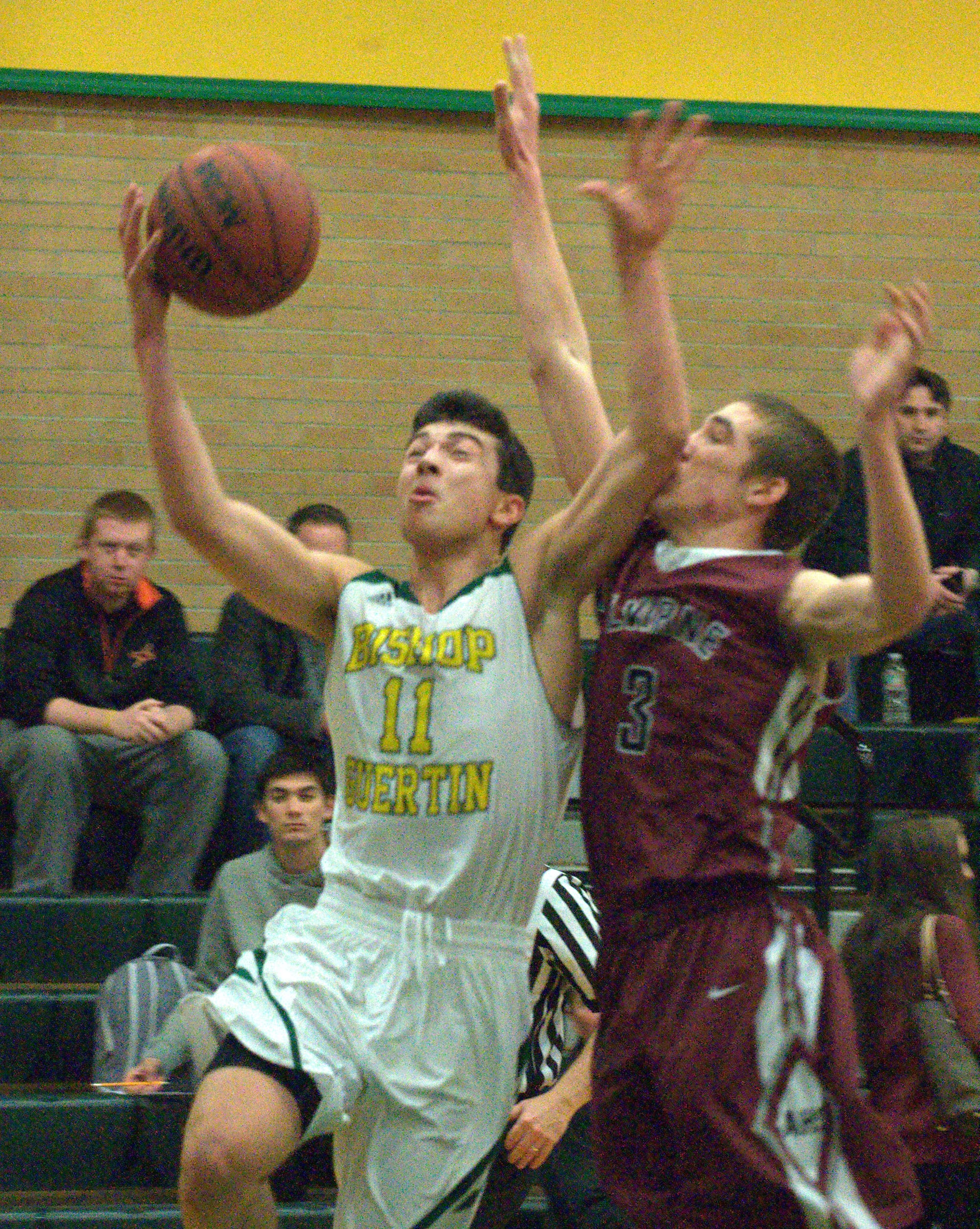 Bishop Guertin's Jack Zimmerman drives to the basket against Alvirne's Dan Tucci.