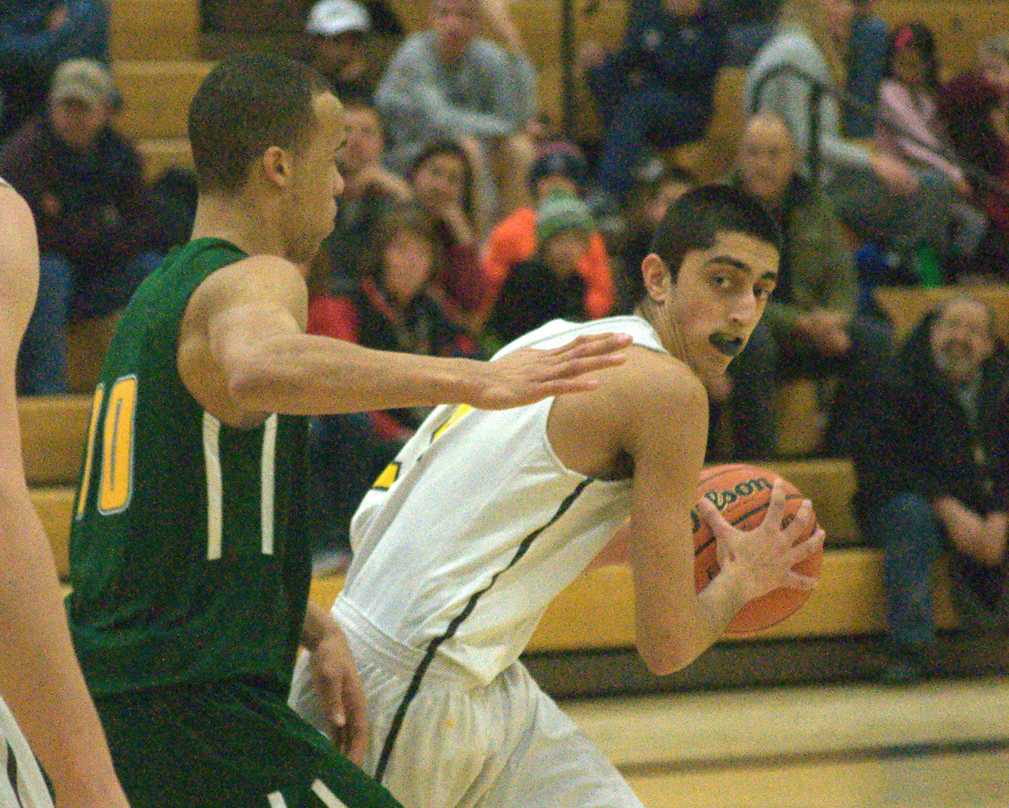 Souhegan's Raju Gandhi looks for a way to pass the ball around Bishop Brady's Jourdain Bell during Friday's game.