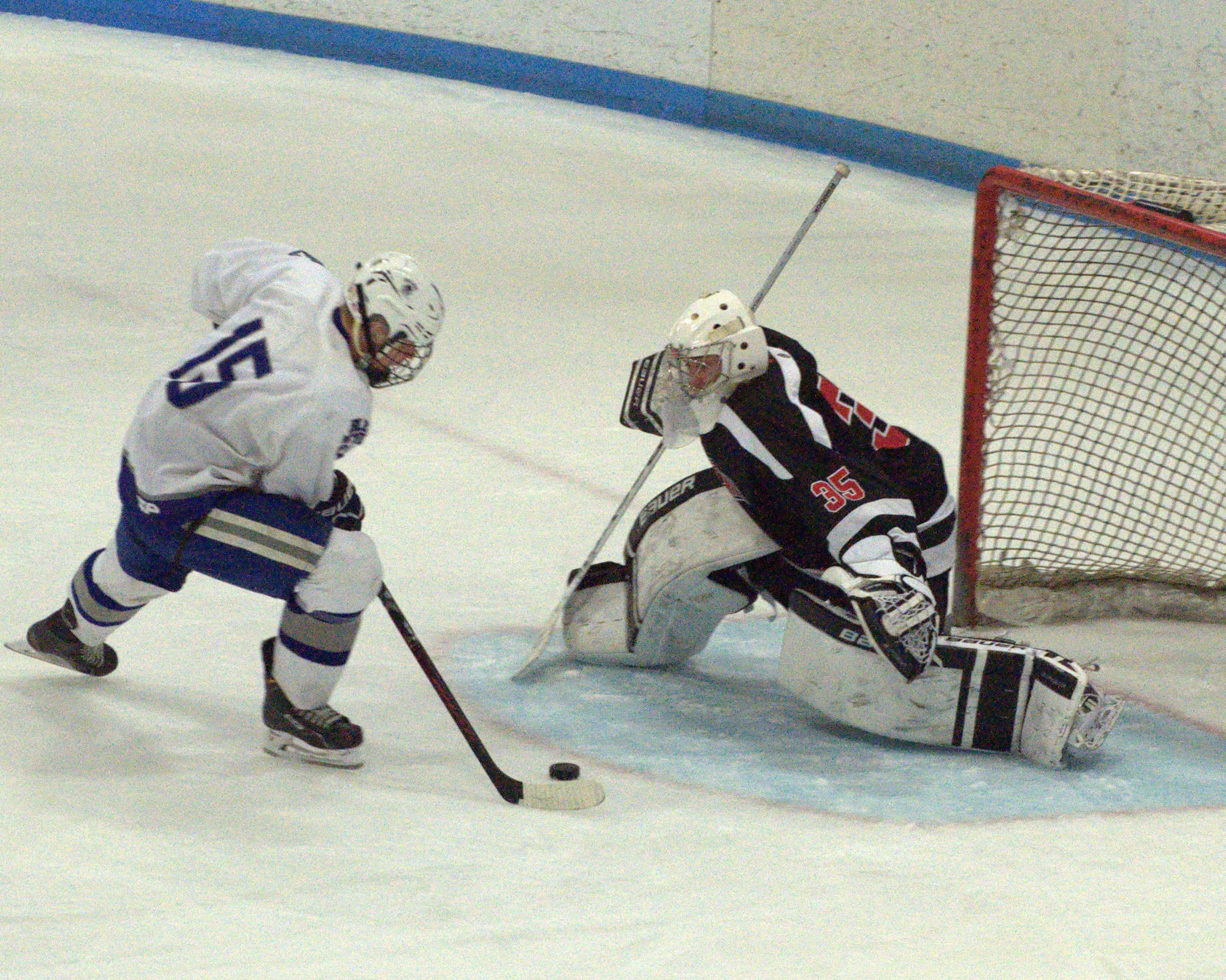 Salem's John Gray skates in on Bedford goalie Alec Lindberg during Saturday's game. Salem handed Bedford its first division loss in almost two years.