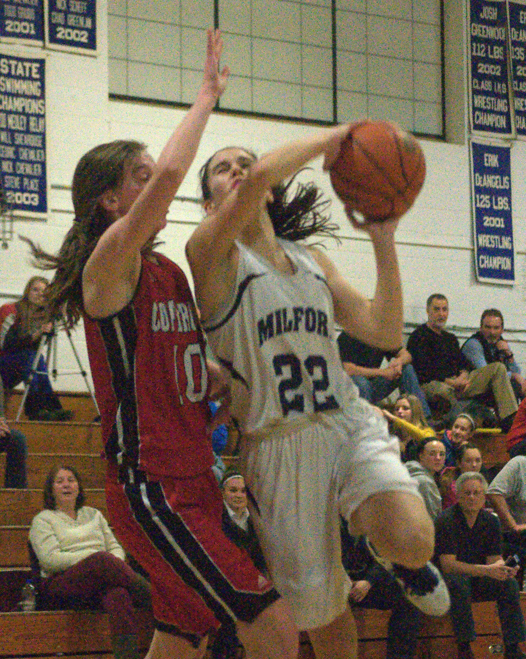 Milford's Amy Arena drives to the basket against Coe-Brown's Jennifer Schlim.
