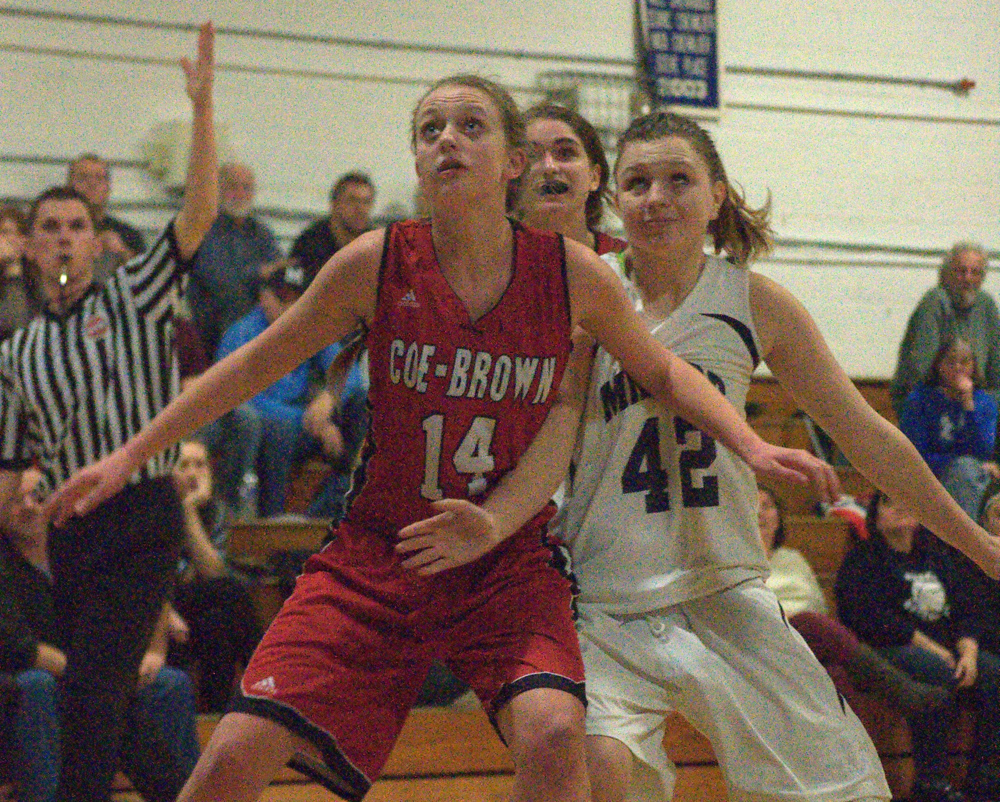 Coe-Brown's Abigail Ahern and Milford's Ari Devine battle for position during Thursday night's game.