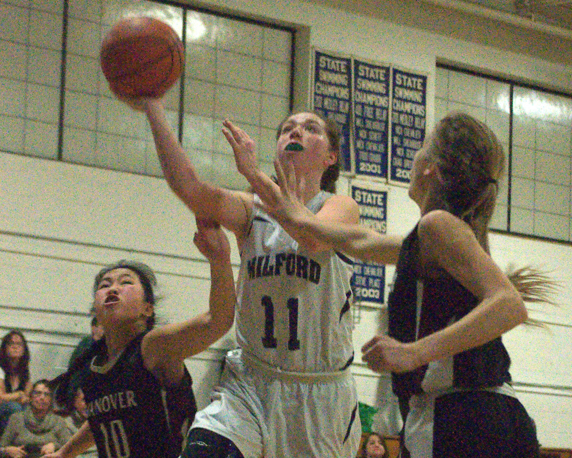 Milford's Kaitlyn Matthews puts up a shot between Hanover's Emma Riccardi, left, and Hannah Wittman during Wednesday's game.