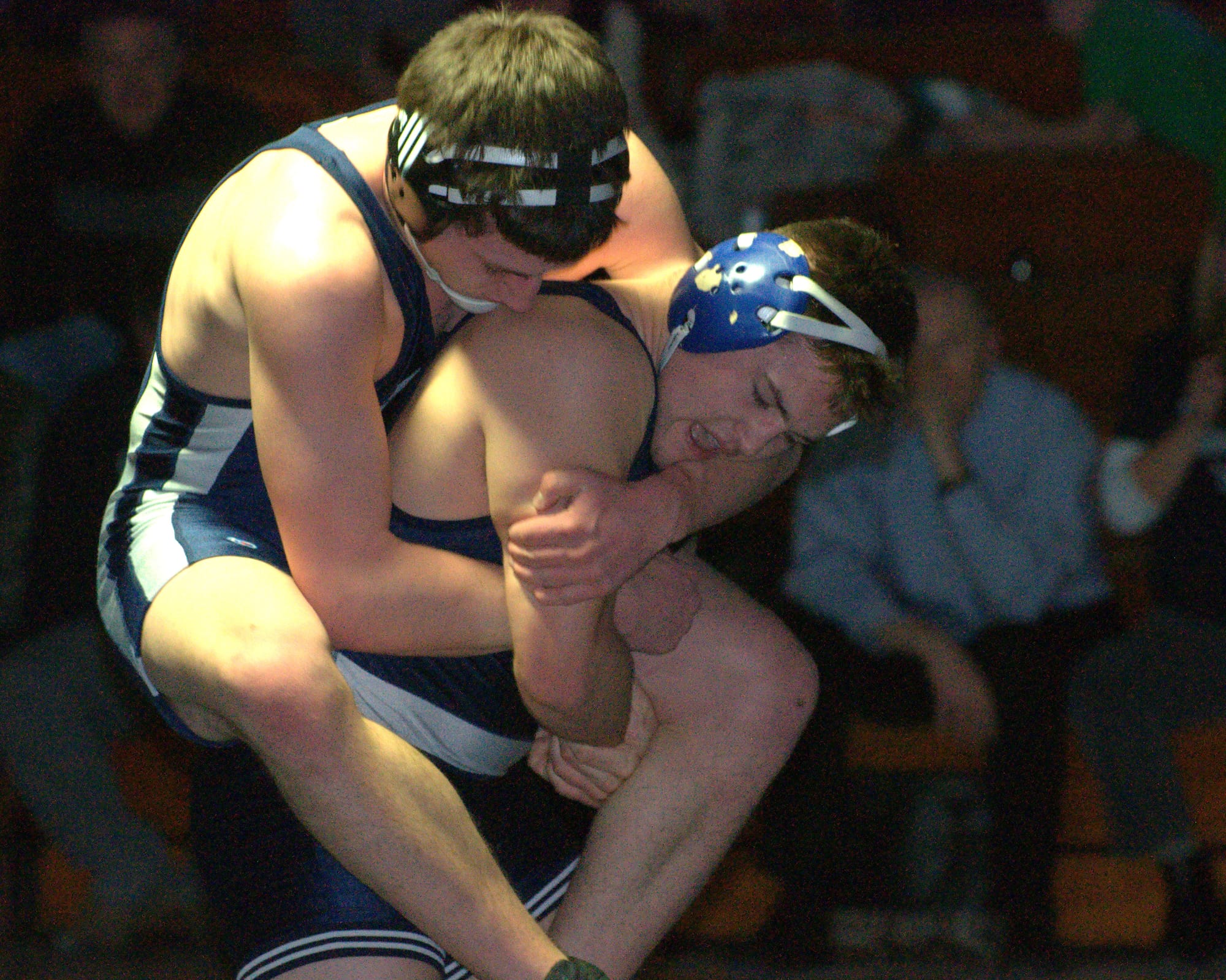 Milford's Jake Ricca gets on the back of Hollis Brookline's Wyatt Farwell during their 170-pound match Wednesday. For more photos, go to the Photo Album.