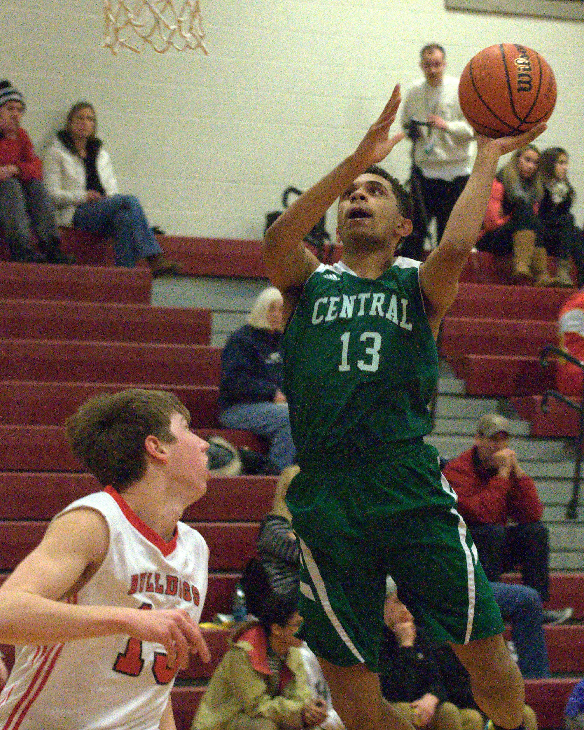 Manchester Central's Jaylen Leroy drives over Bedford's Colby Gendron for a basket during Thursday's game. For more photos, go to the Photo Album.