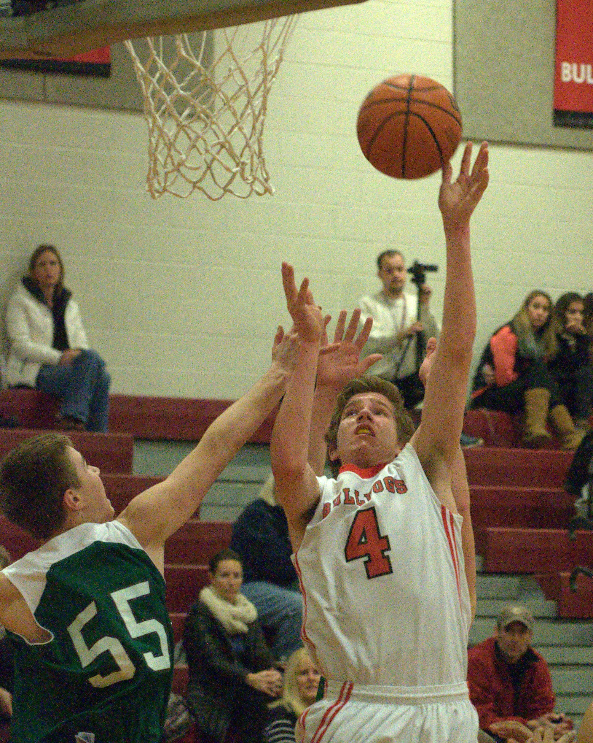 Bedford's Joshua Bauer puts up a shot as Manchester Central's Eli Kacavas defends.
