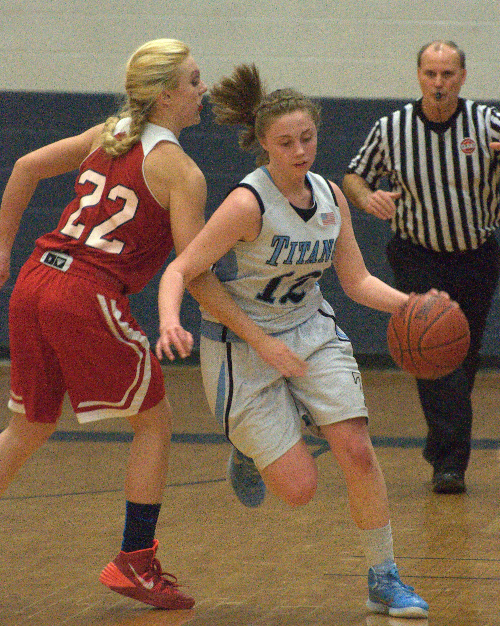 Manchester Memorial's Jess Sweetser tries to slow down Nashua North's Sara Cordova.
