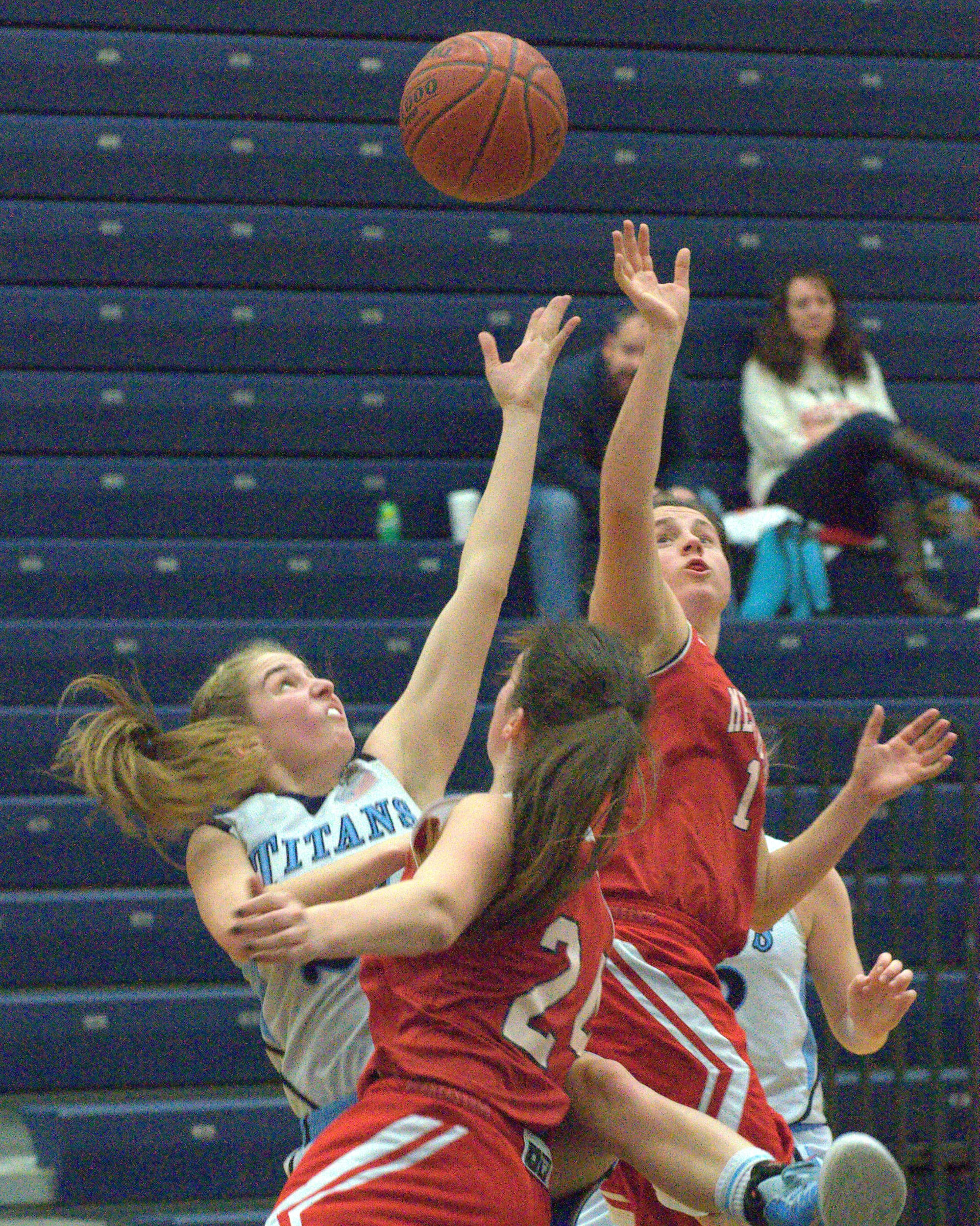 Nashua North's Isabel Dunning battles with Manchester Memorial's Makenah Grisson, center, and Olivia Ross for a rebound Thursday night. For more photos, go to the Photo Album.