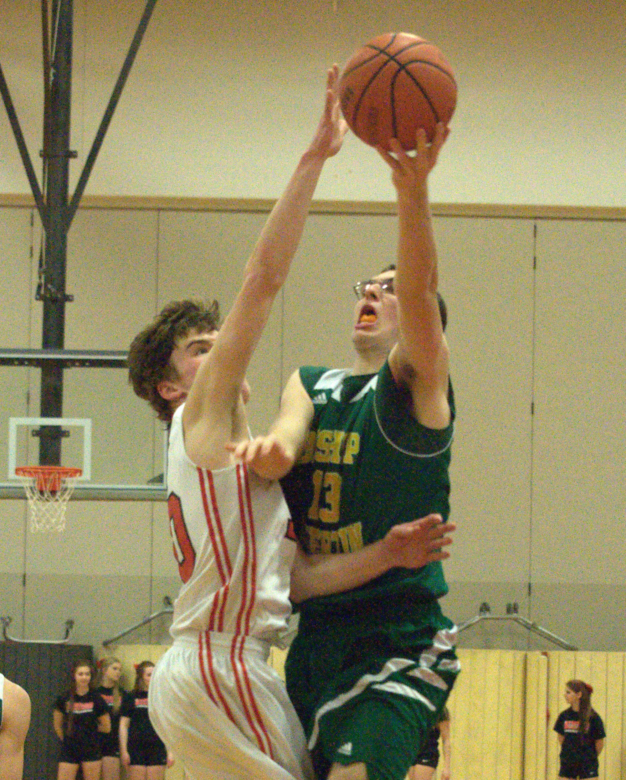 Bedford's Ryan Hughes tries to block a shot by Bishop Guertin's Chad Olivieri during Wednesday's preliminary round game.