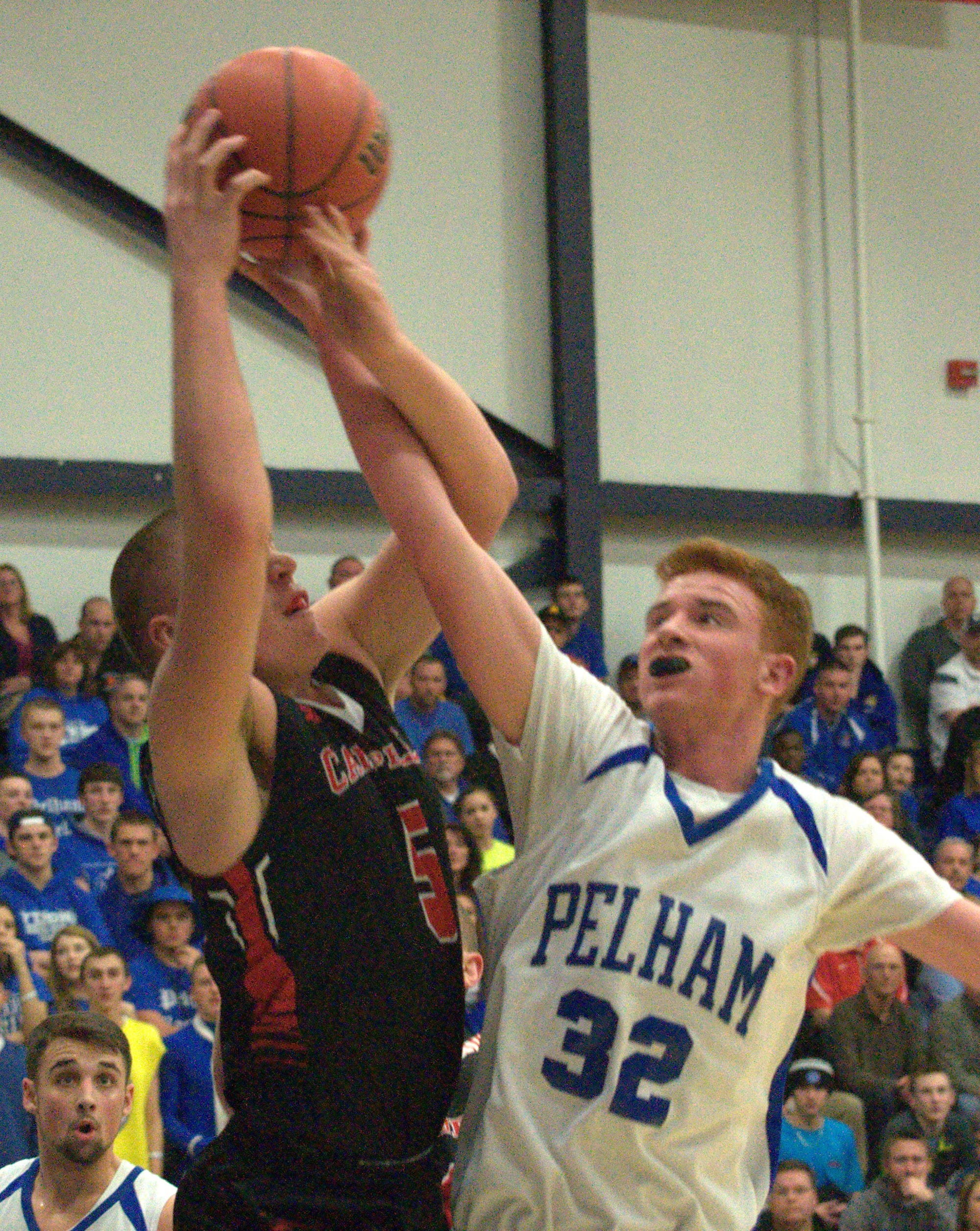 Campbell's Harrison Vedrani and Pelham's David Rogers battle for a rebound.