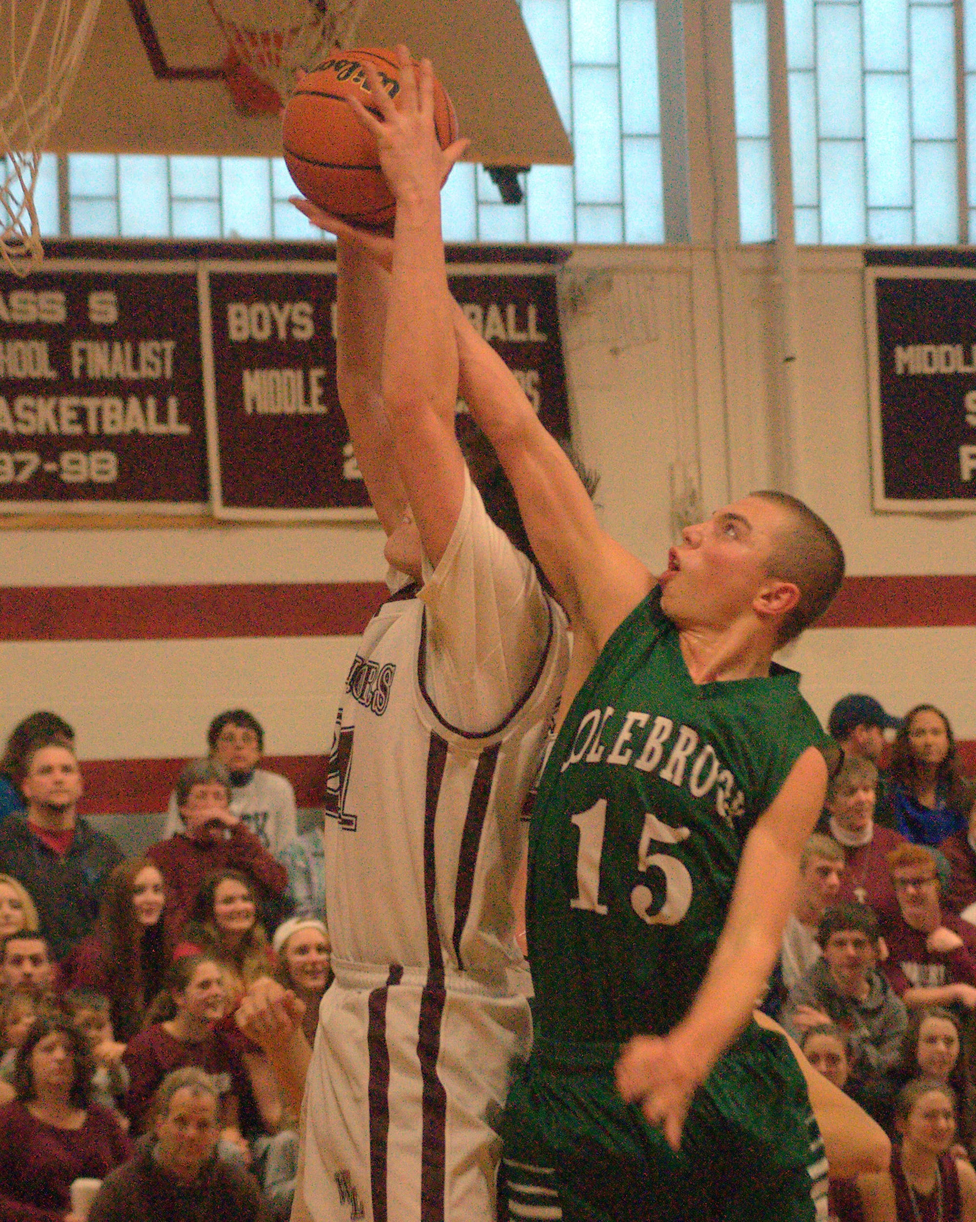 Colebrook's Sedrick McKinnon and Wilton-Lyndeborough's Connor Melrose battle for a rebound.