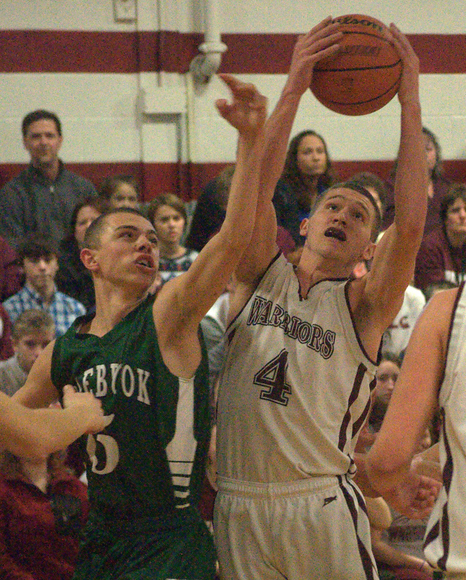 Wilton-Lyndeborough's Jordan Litts and Colebrook's Sedrick McKinnon battle for a rebound during Friday's game.