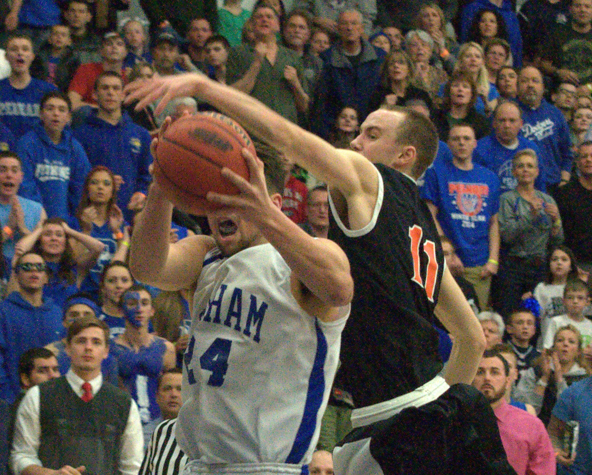 Conant's Josh Degrenier tries to block a shot by Pelham's Keith Brown.