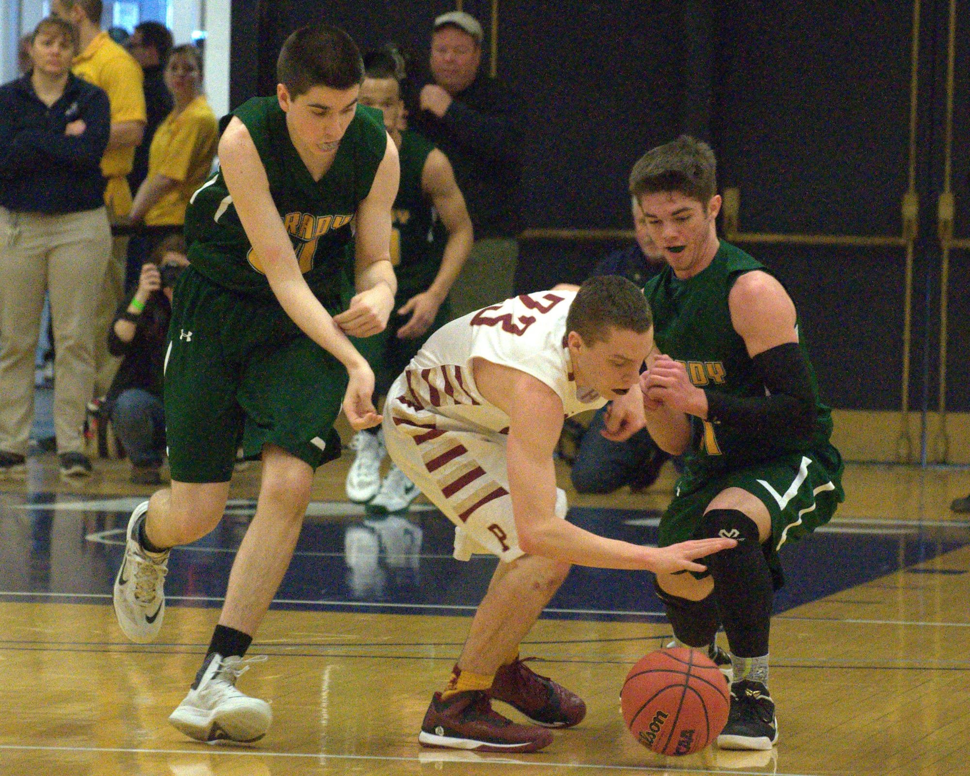 Bishop Brady's Matt Desmarais, left, and Brendan Johnson try to take the ball from Portsmouth's Cody Graham.