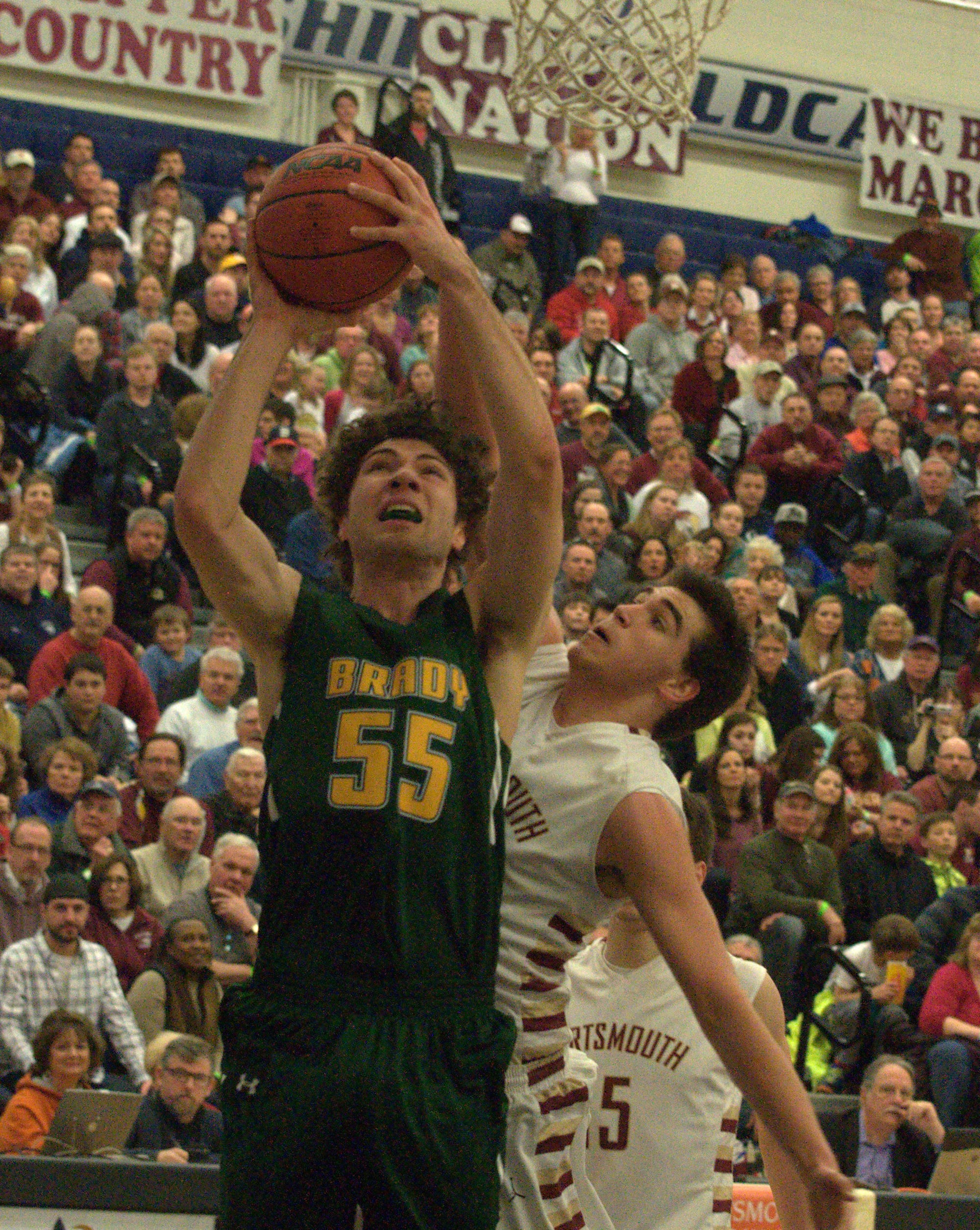 Portsmouth's Joey Glynn tries to block a shot by Bishop Brady's Aaron Svendsen.