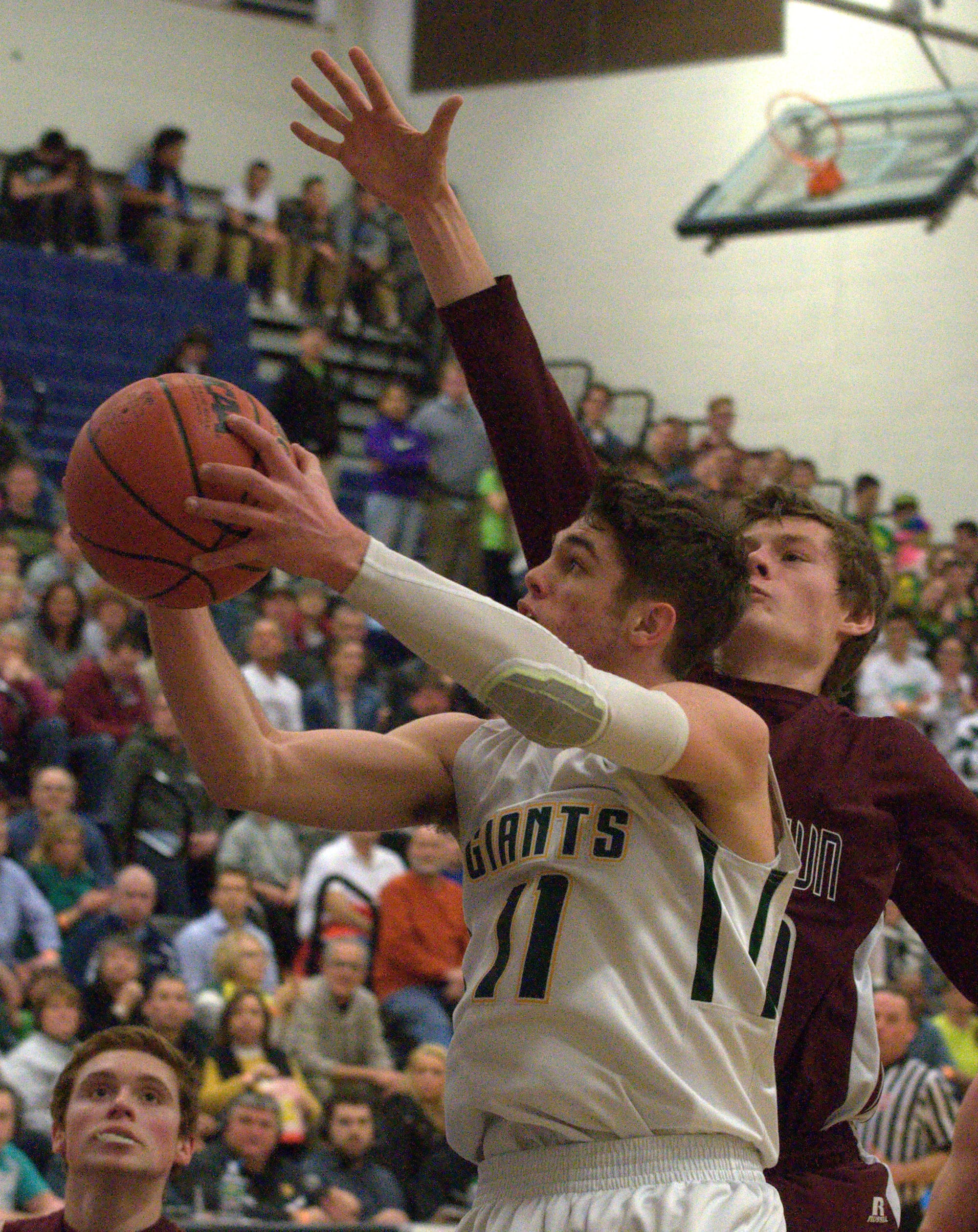 Bishop Brady's Brendan Johnson drives to the basket against Goffstown's Ben Barss.