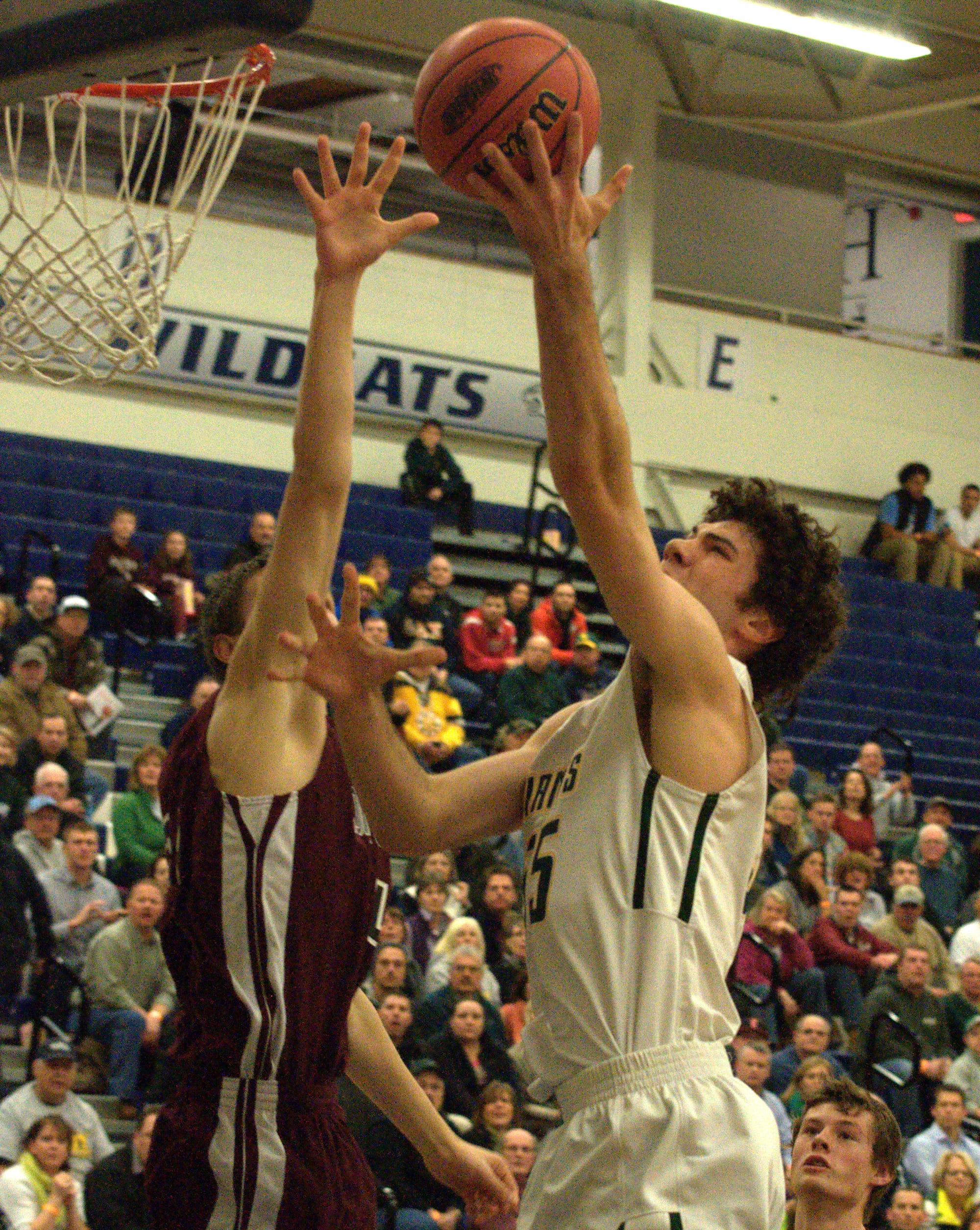 Bishop Brady's Aaron Svendsen goes in for a layup as Goffstown's Robert Girardin defends.