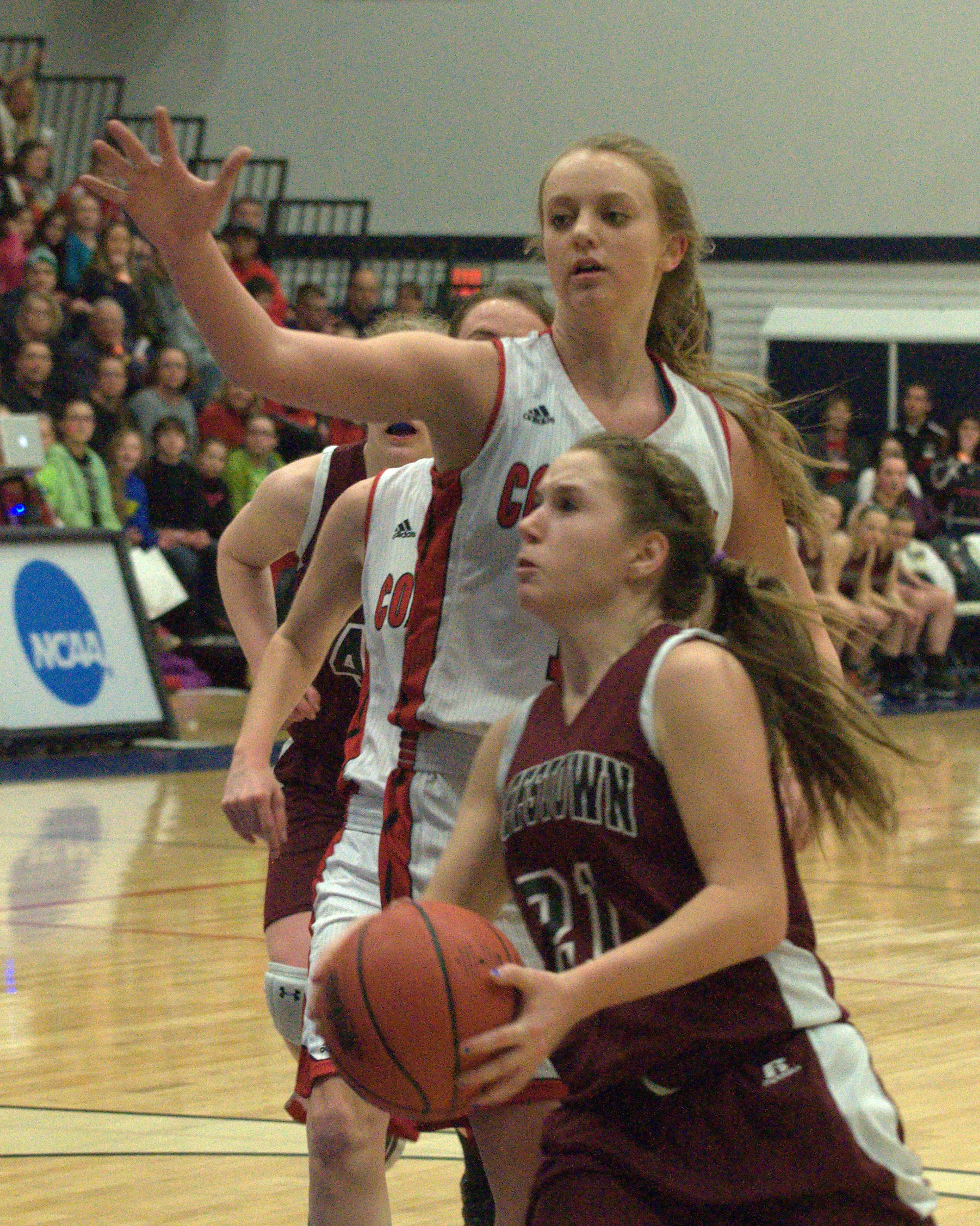 Coe-Brown's Abigail Ahern defends as Goffstown's Molly Mcqueeney drives to the basket.